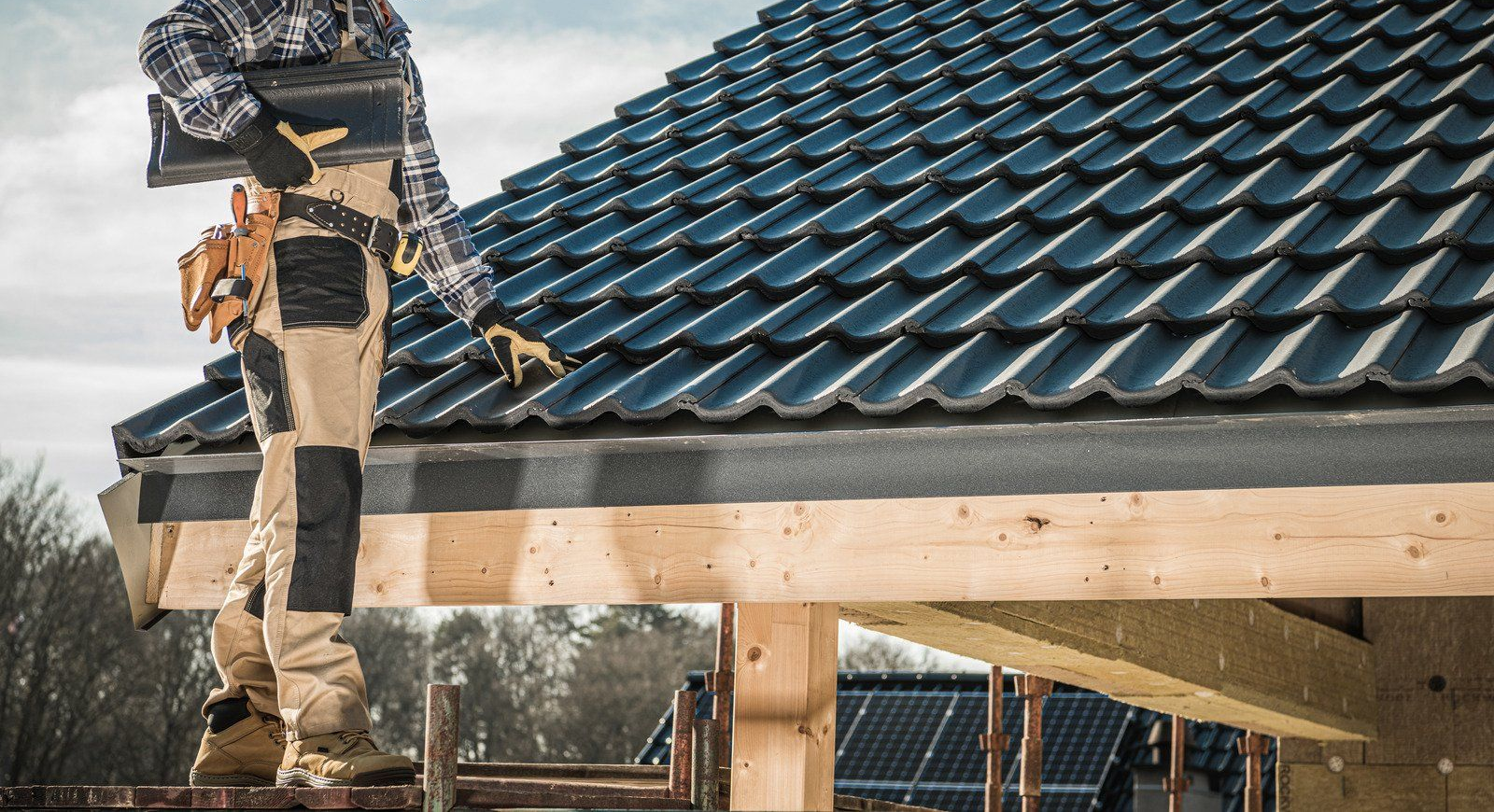 Woman smiles, pushing a cleaning cart down a well-lit hallway.