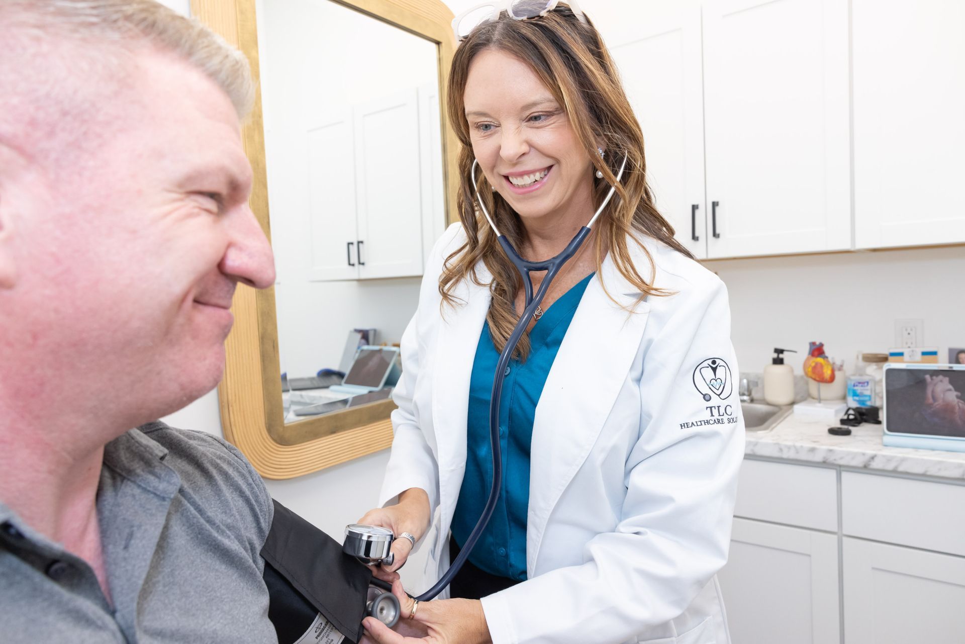 A doctor showing a mobile device to an older woman