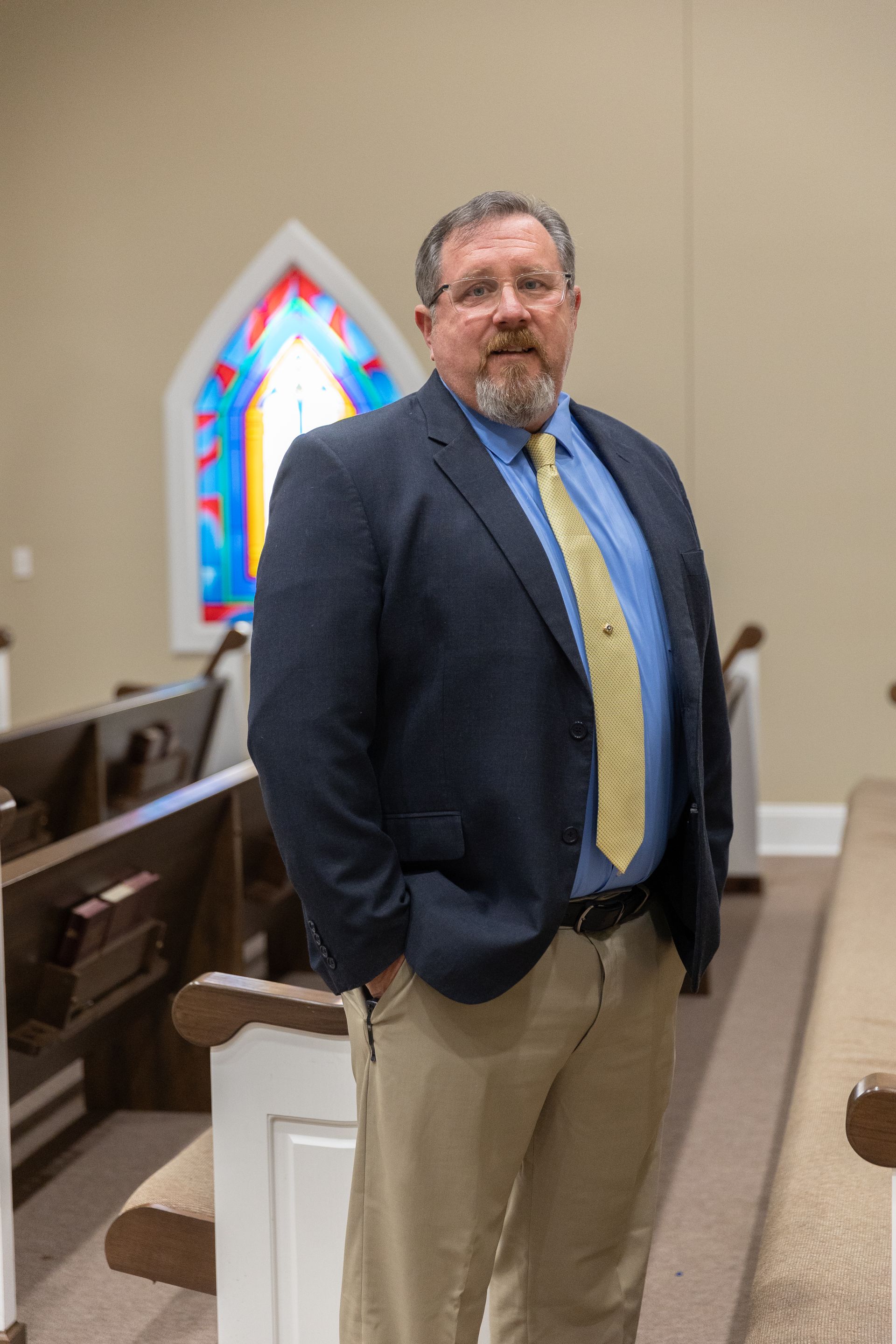 A man with a beard is wearing a suit and tie.