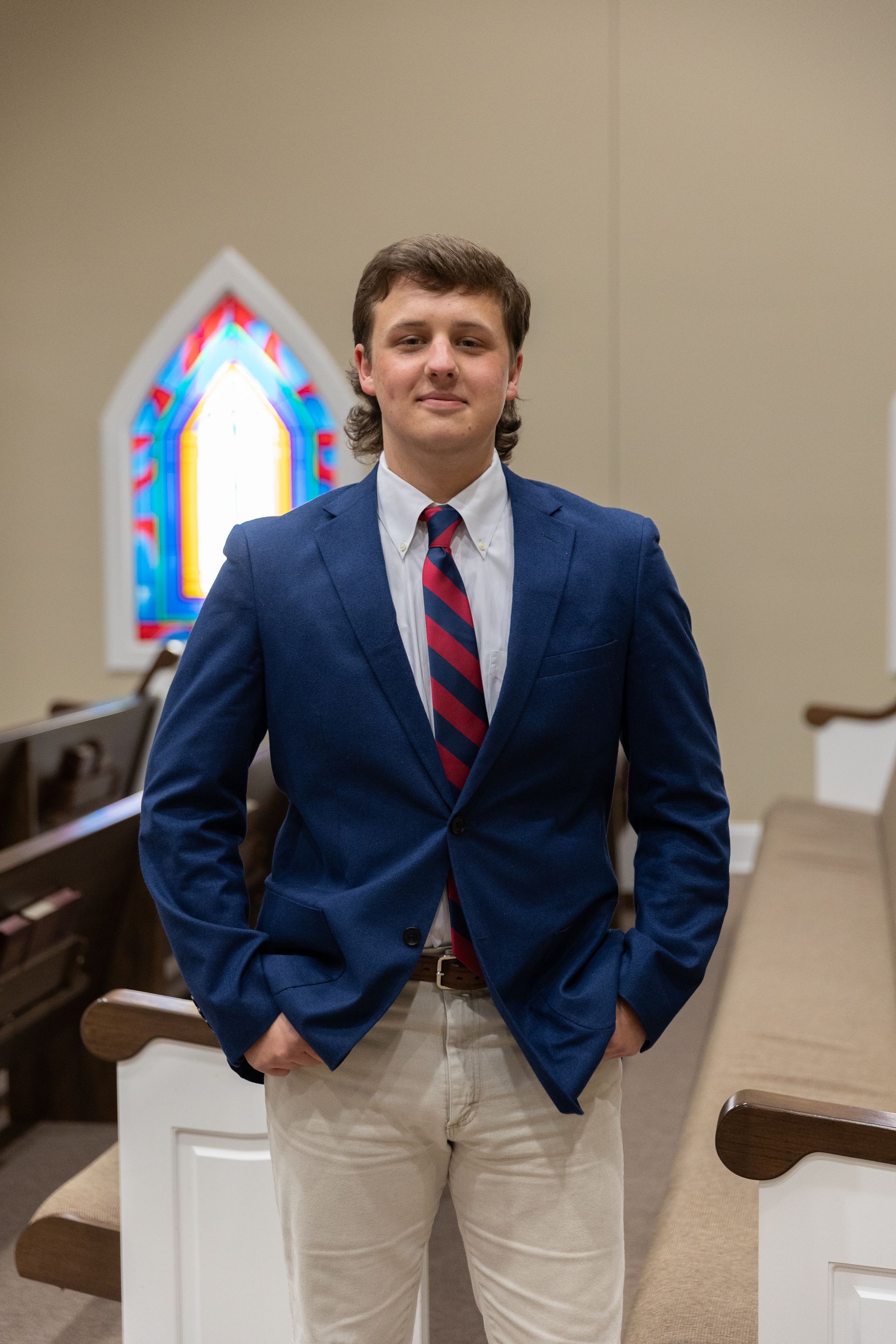A man with a beard is wearing a suit and tie.