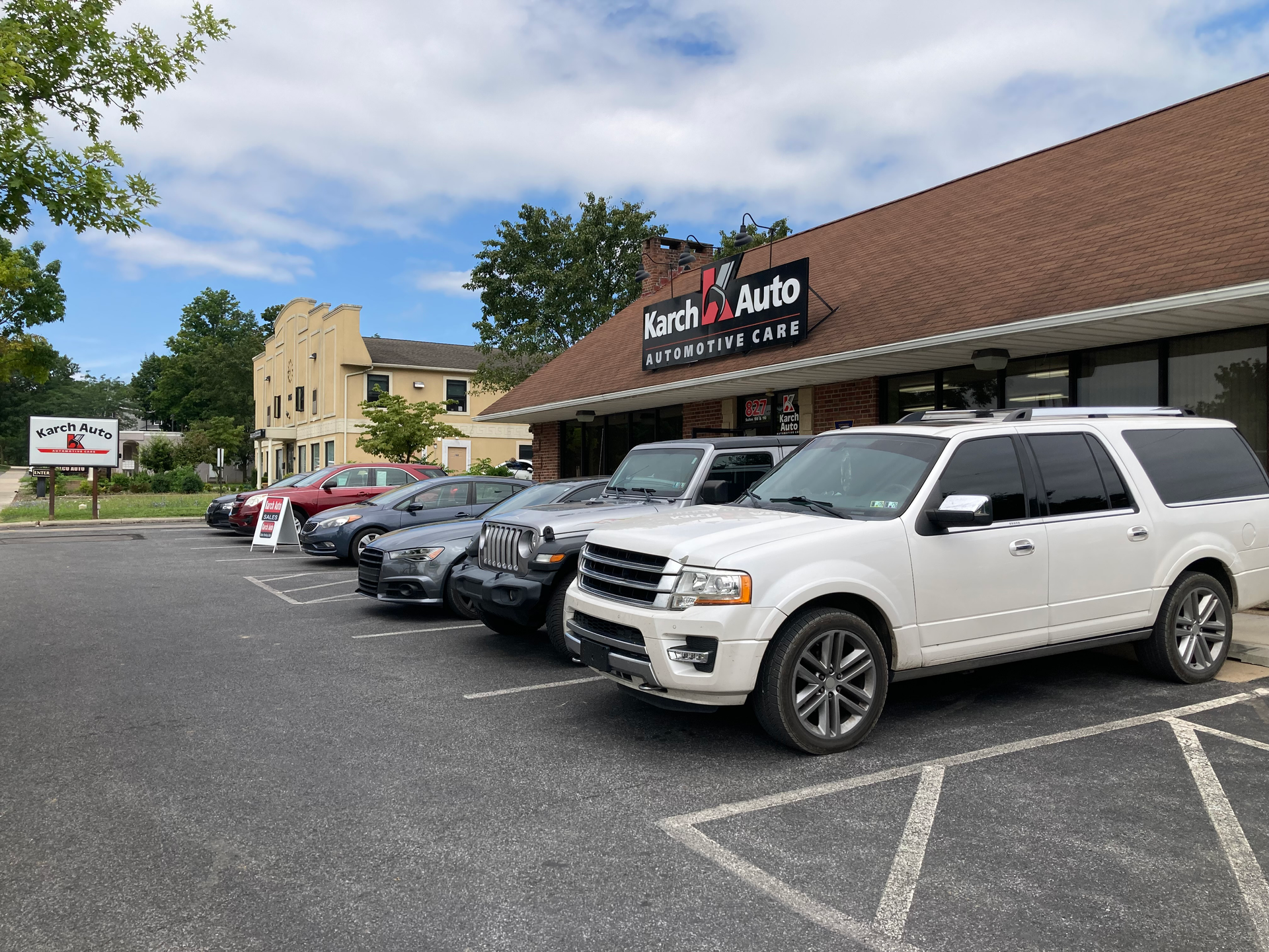 Mechanic working on a car, with icons showing vehicle diagnostics, repair, and planning. | Karch Auto