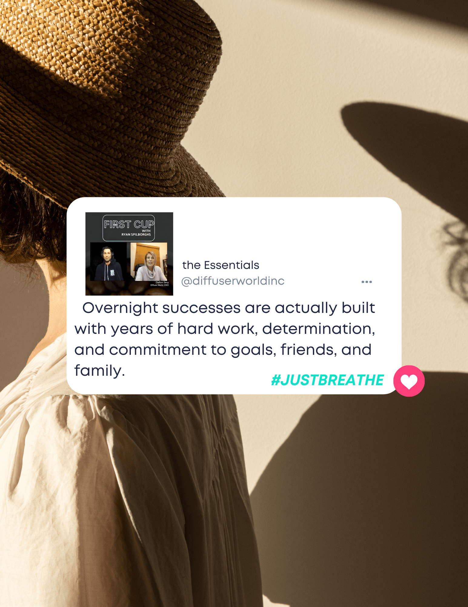 A woman wearing a hat and a white shirt is standing in front of a wall.