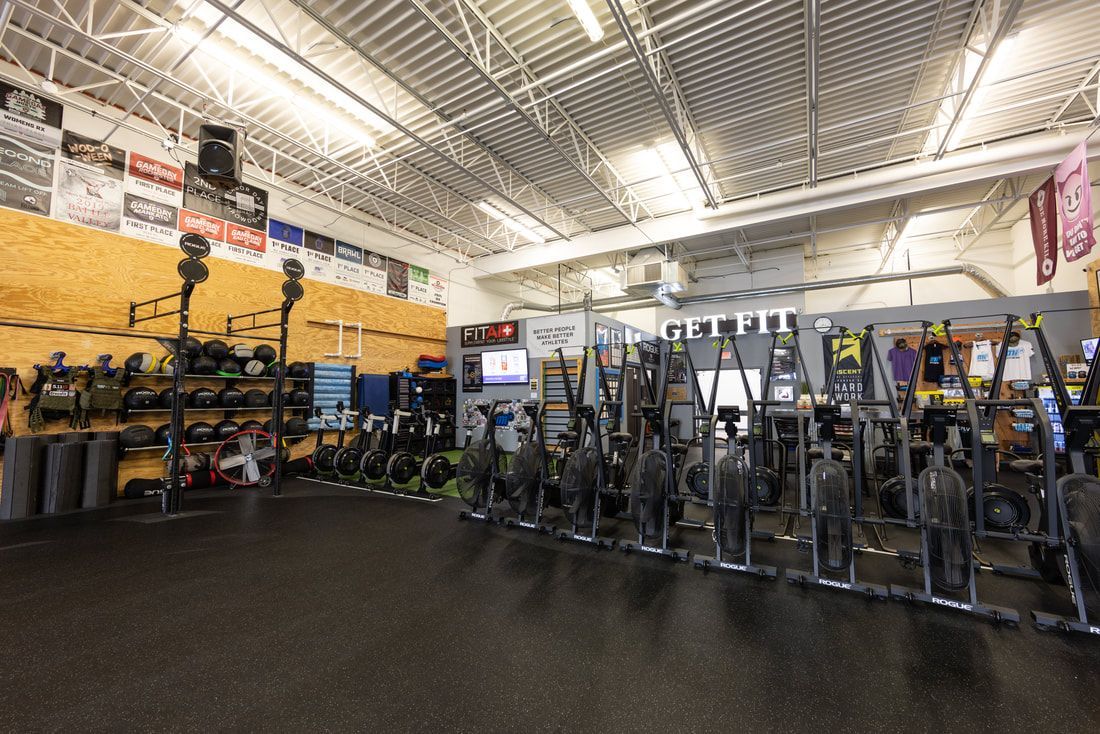 A gym filled with lots of exercise equipment.