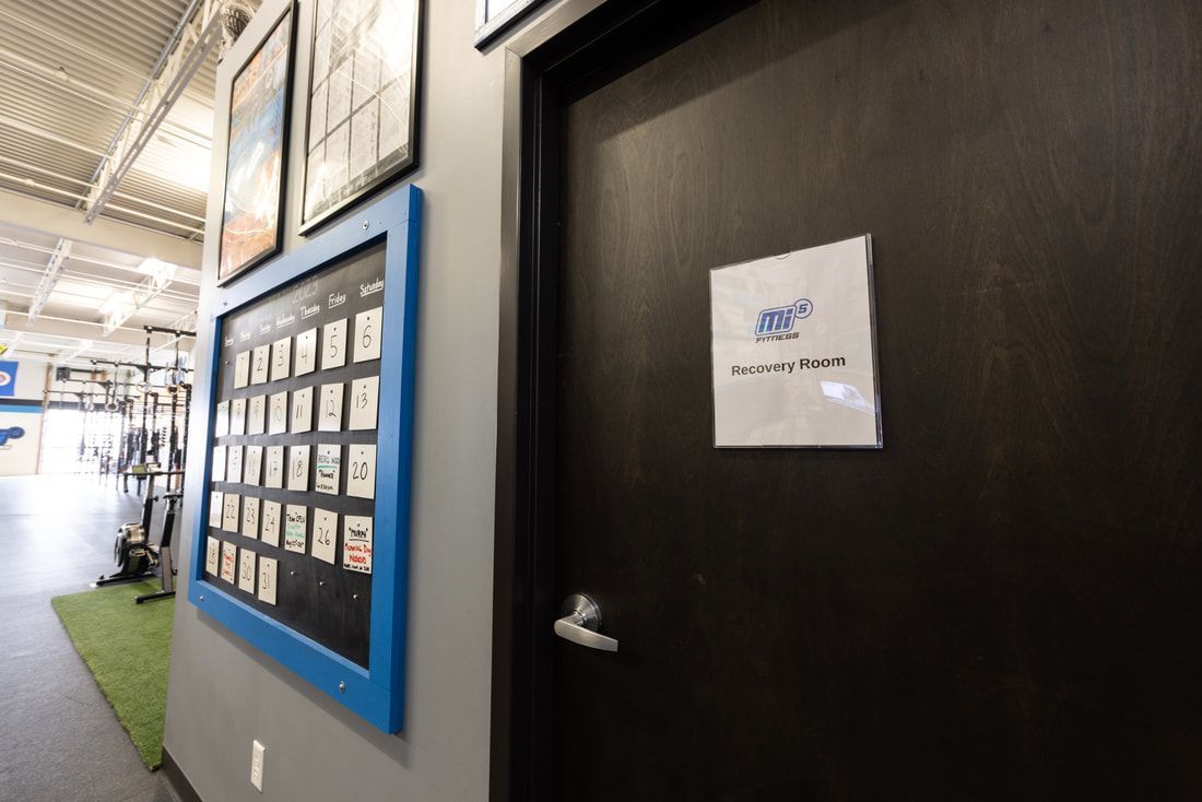 A door in a gym with a sign on it.
