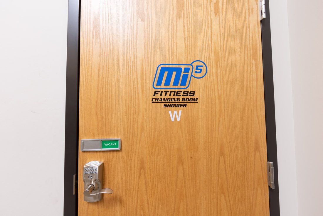 A wooden door with the word fitness on it