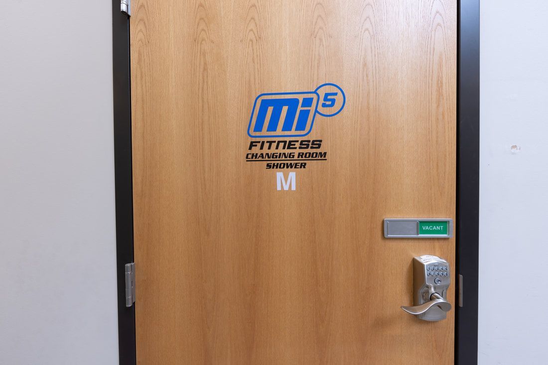A wooden door with the word fitness on it.