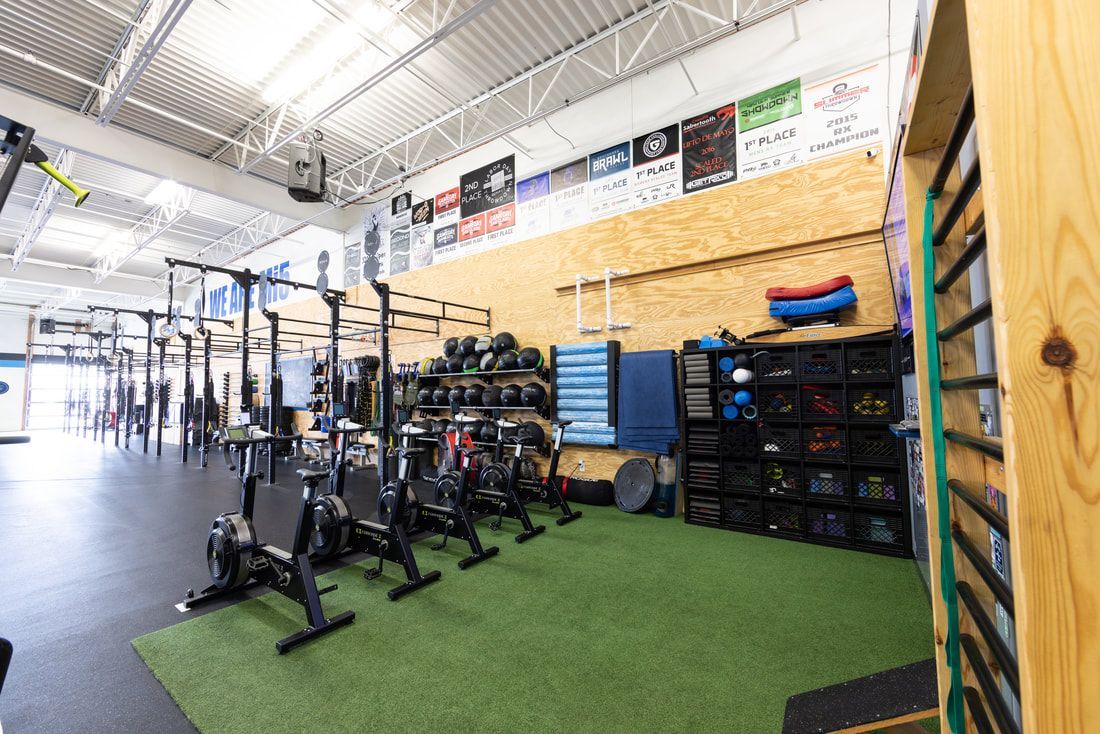 A large gym filled with lots of exercise equipment.