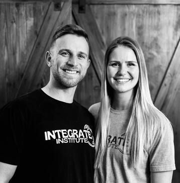 A man and a woman are posing for a picture in a black and white photo.