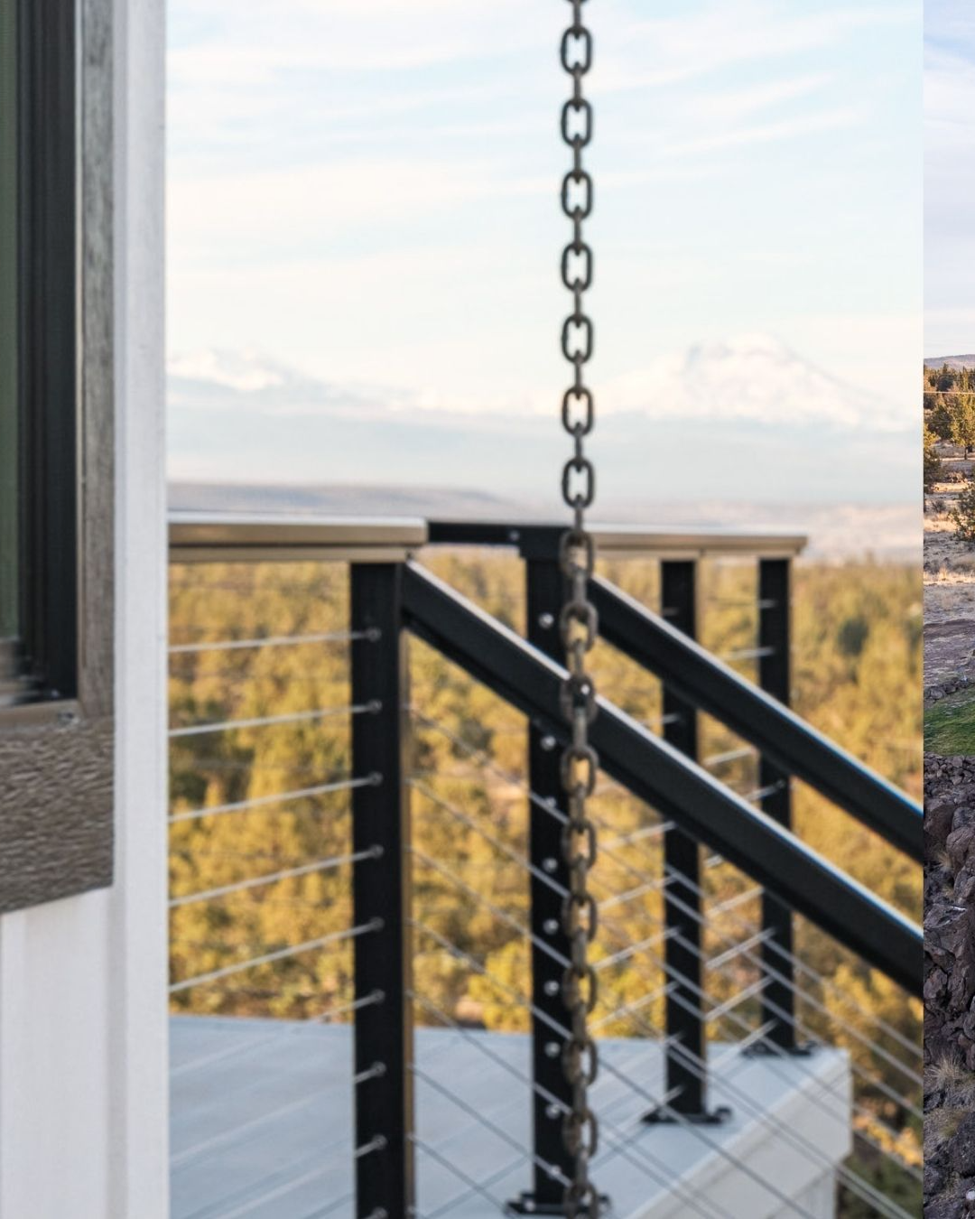 Black chain rain gutter next to black railing on a deck with a mountain view.