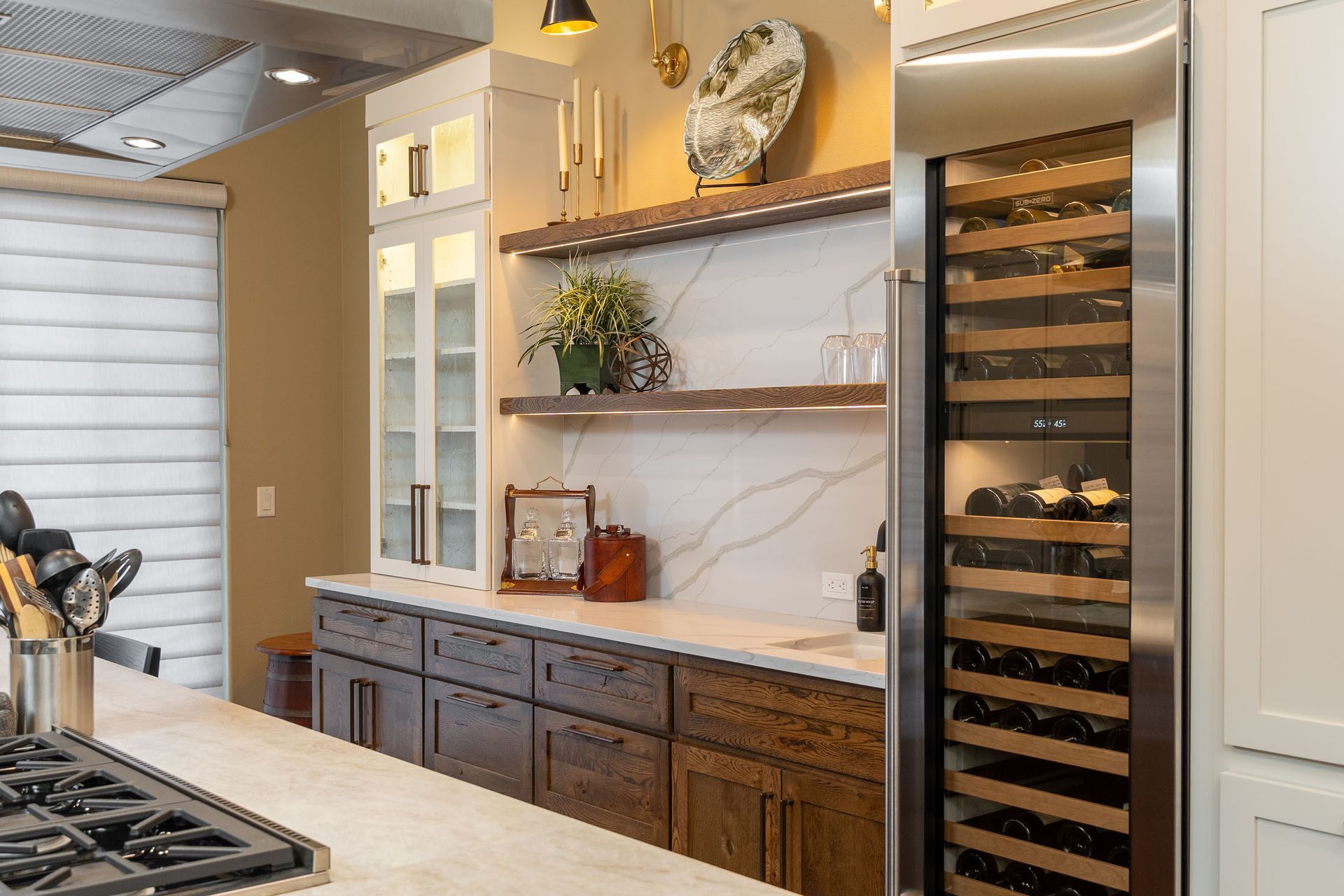 A kitchen with stainless steel appliances and a wine cooler.