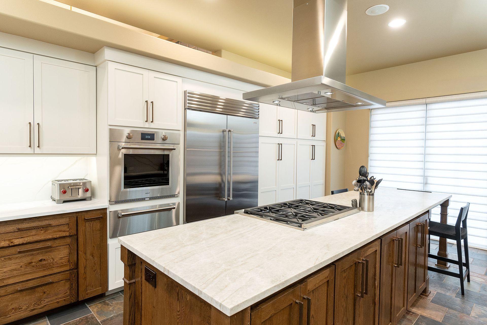 A kitchen with stainless steel appliances and a large island.