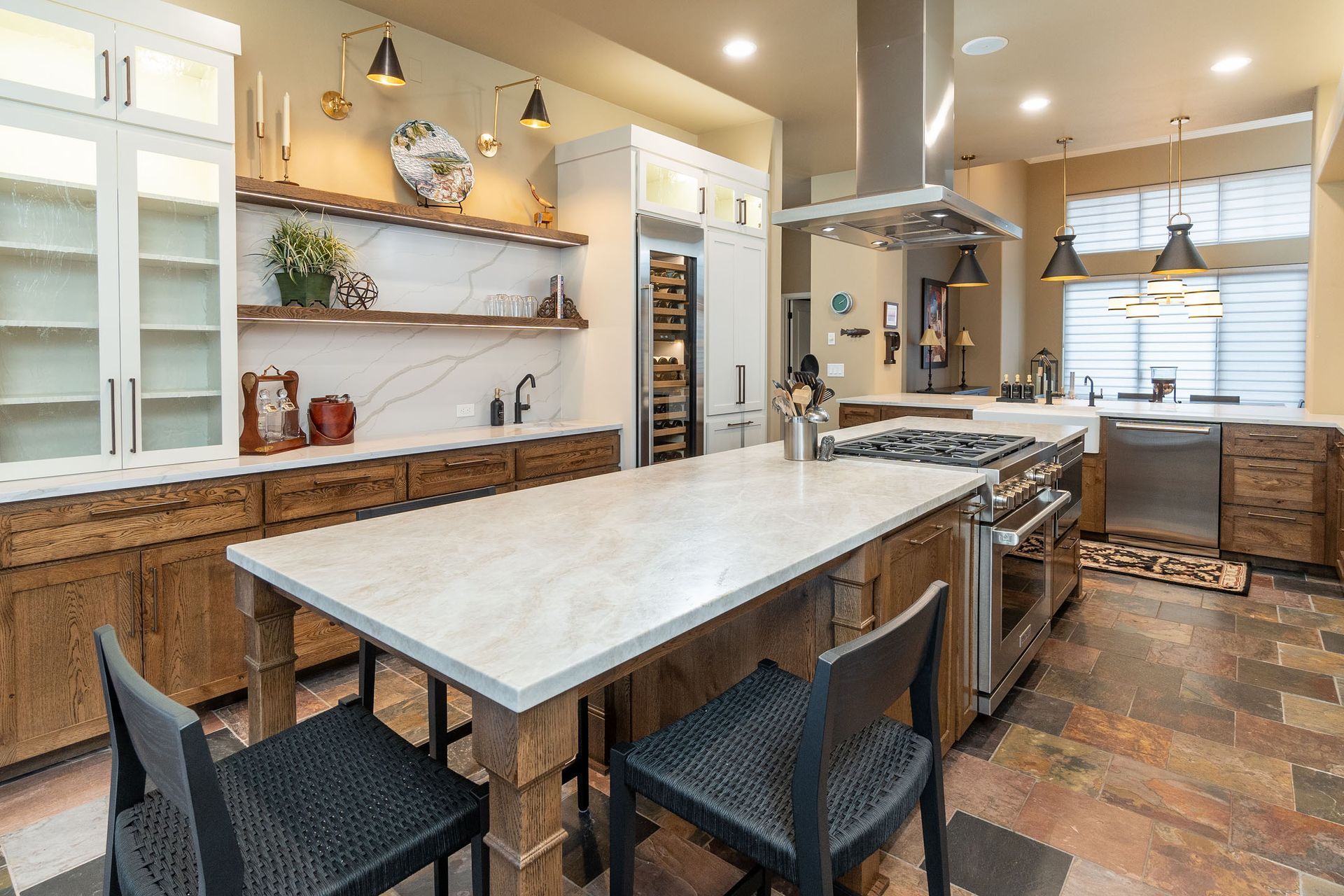 A kitchen with a large island and stainless steel appliances.