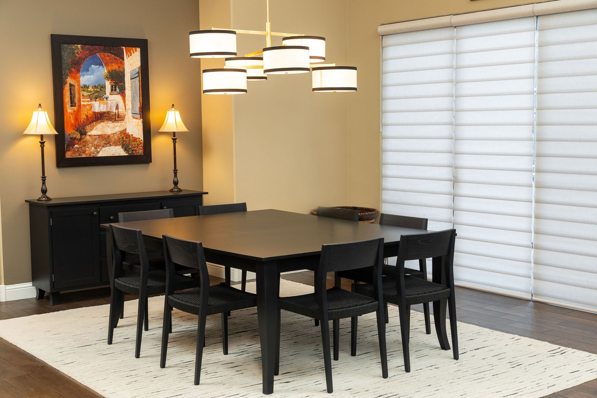 A dining room with a large table and chairs