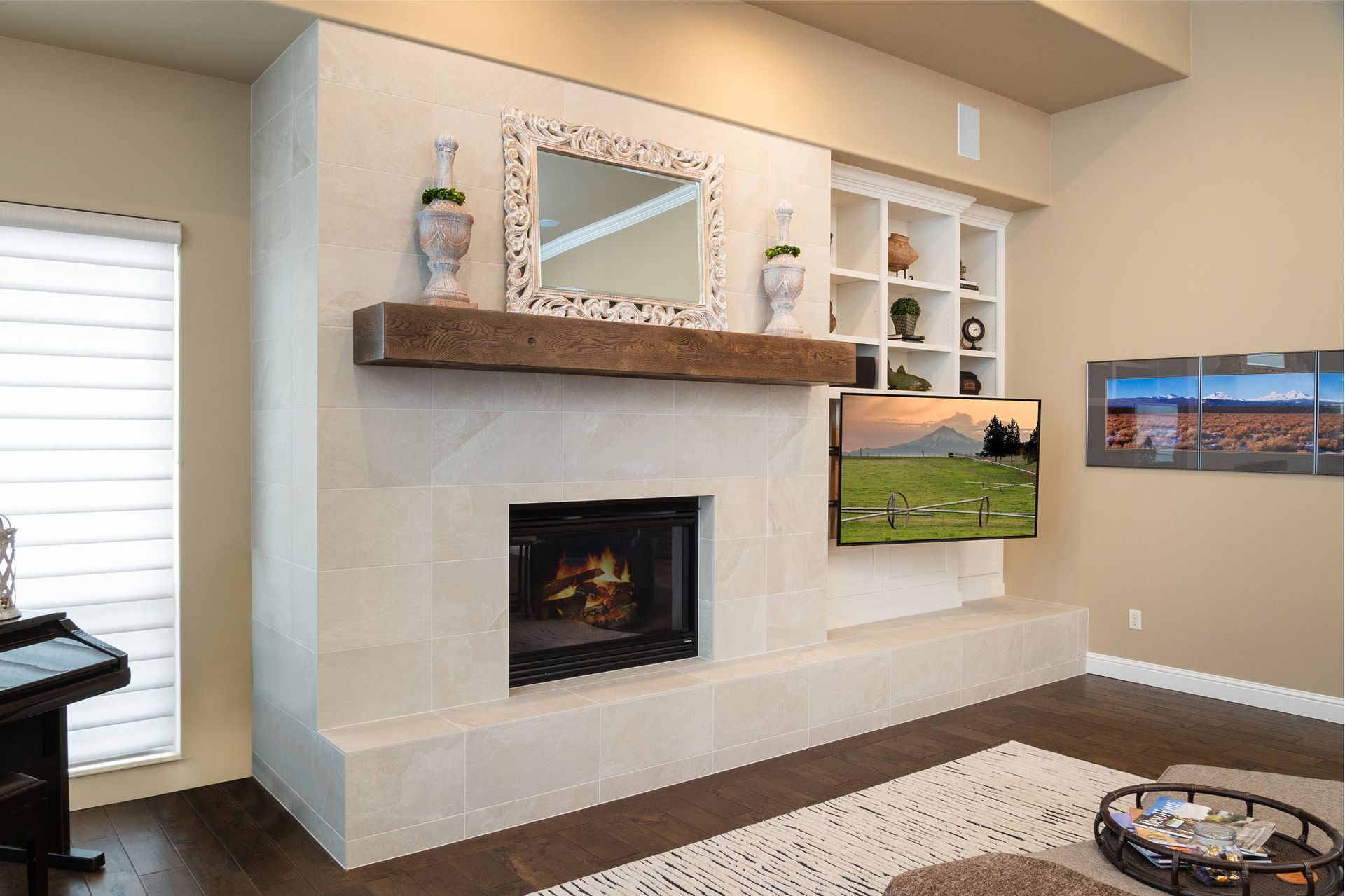 A living room with a fireplace and a flat screen tv on the wall.