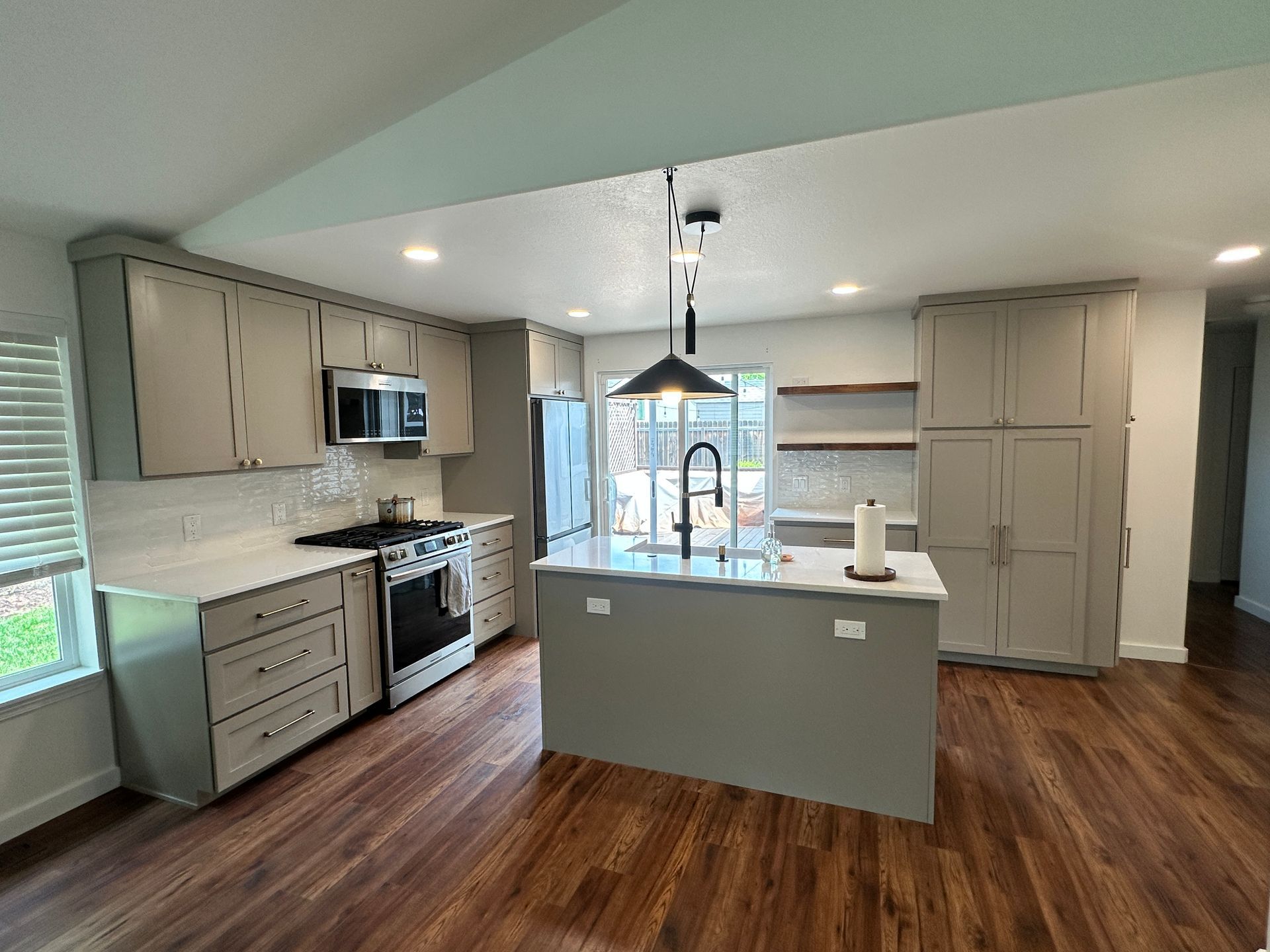 A kitchen with a large island and stainless steel appliances.