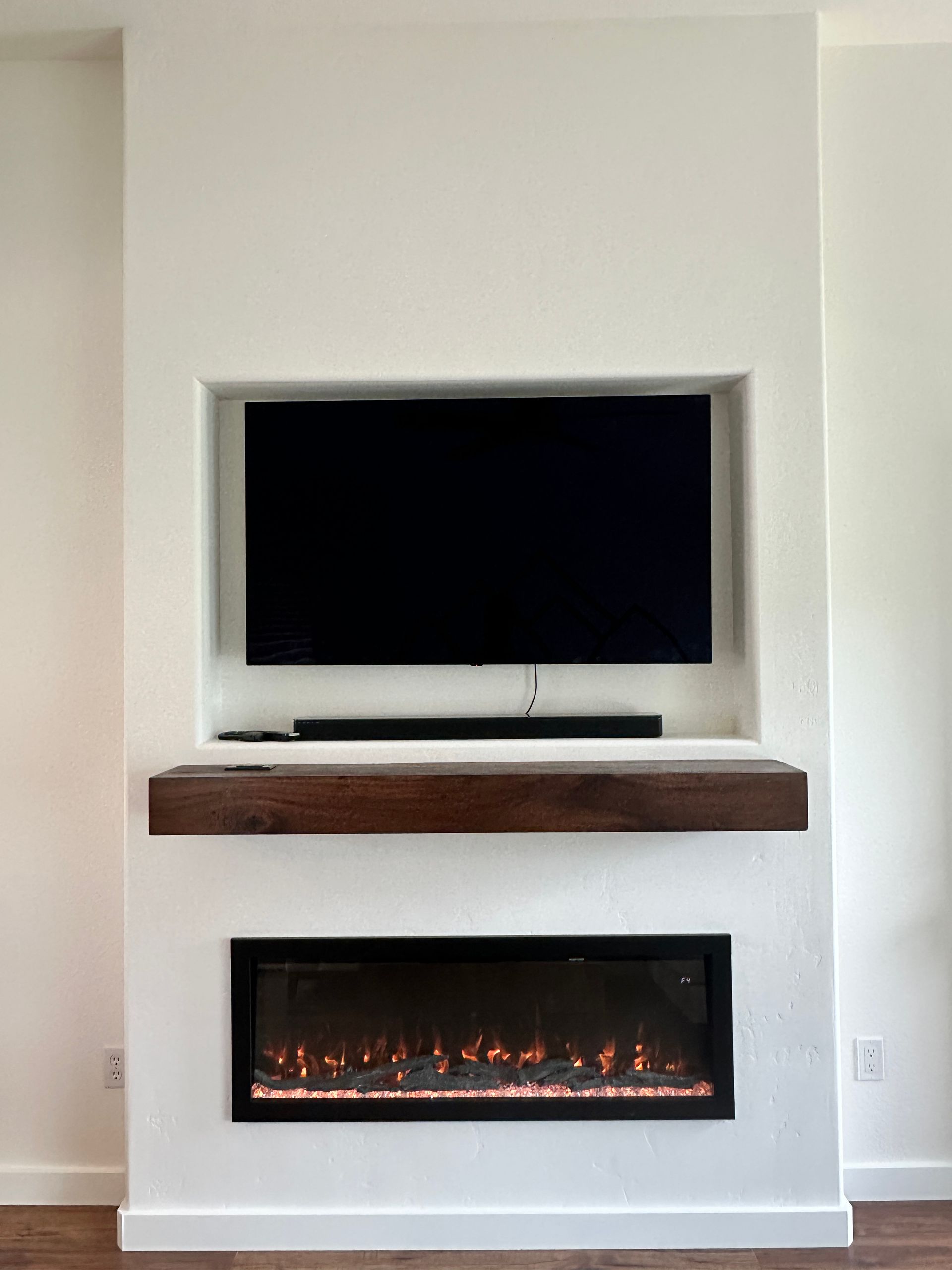 A fireplace with a flat screen tv mounted above it.