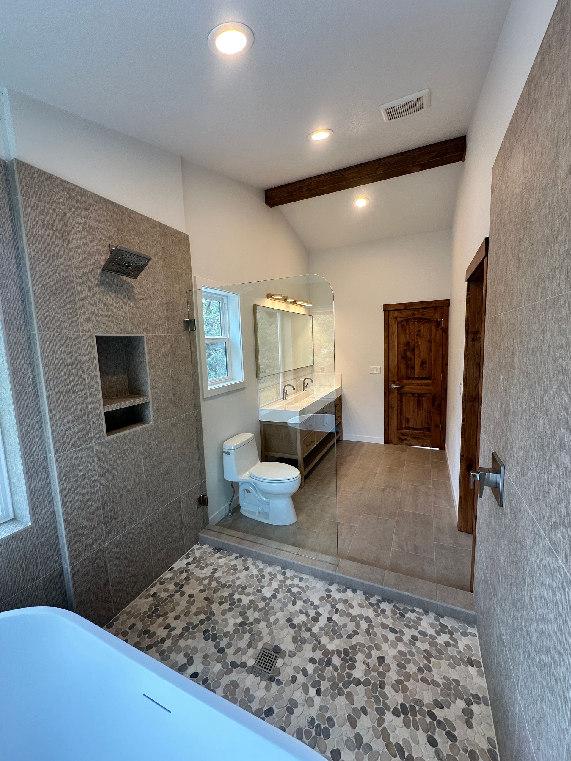 A bathroom with a toilet , sink , and shower.