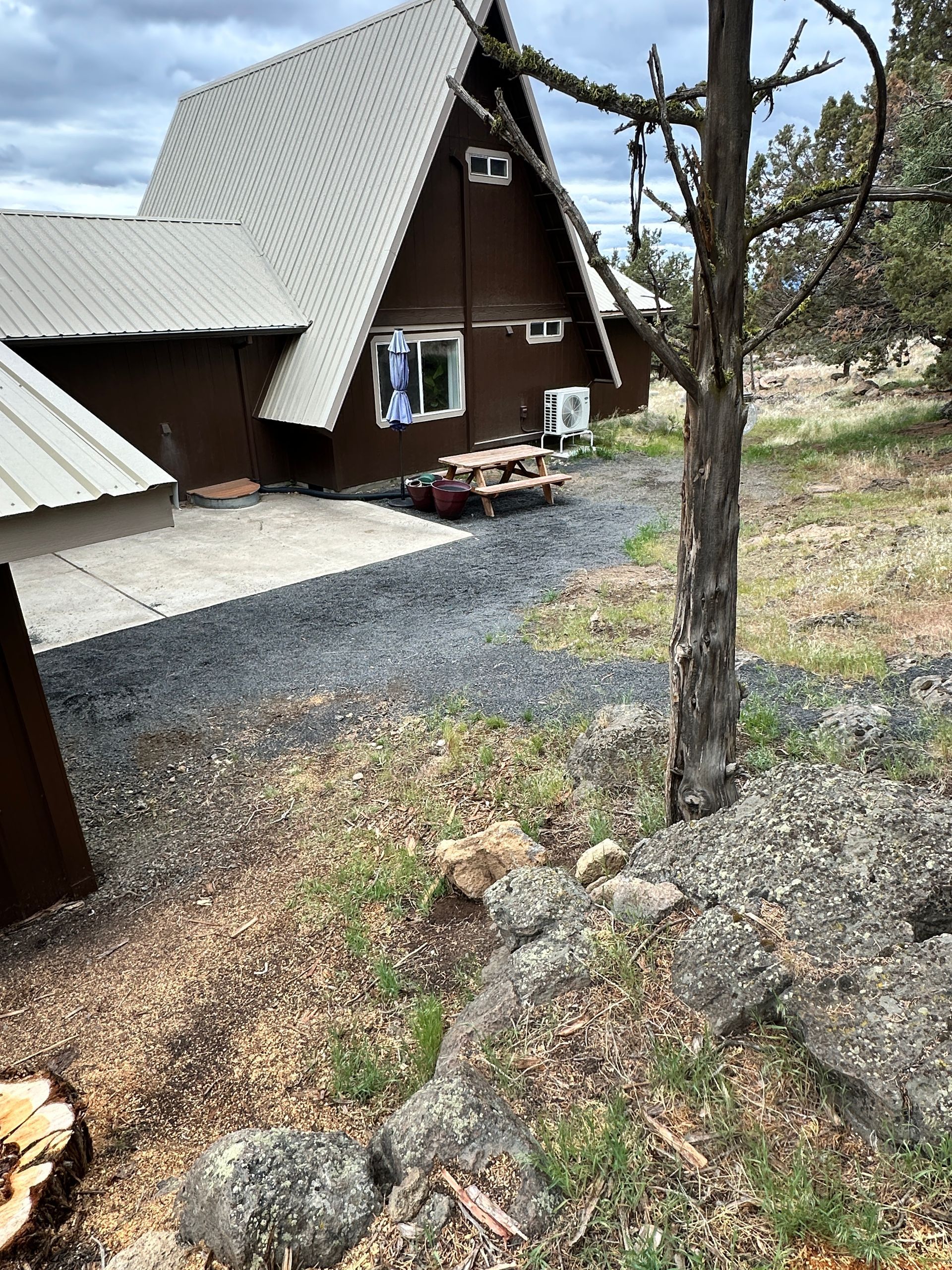 A house with a picnic table in front of it