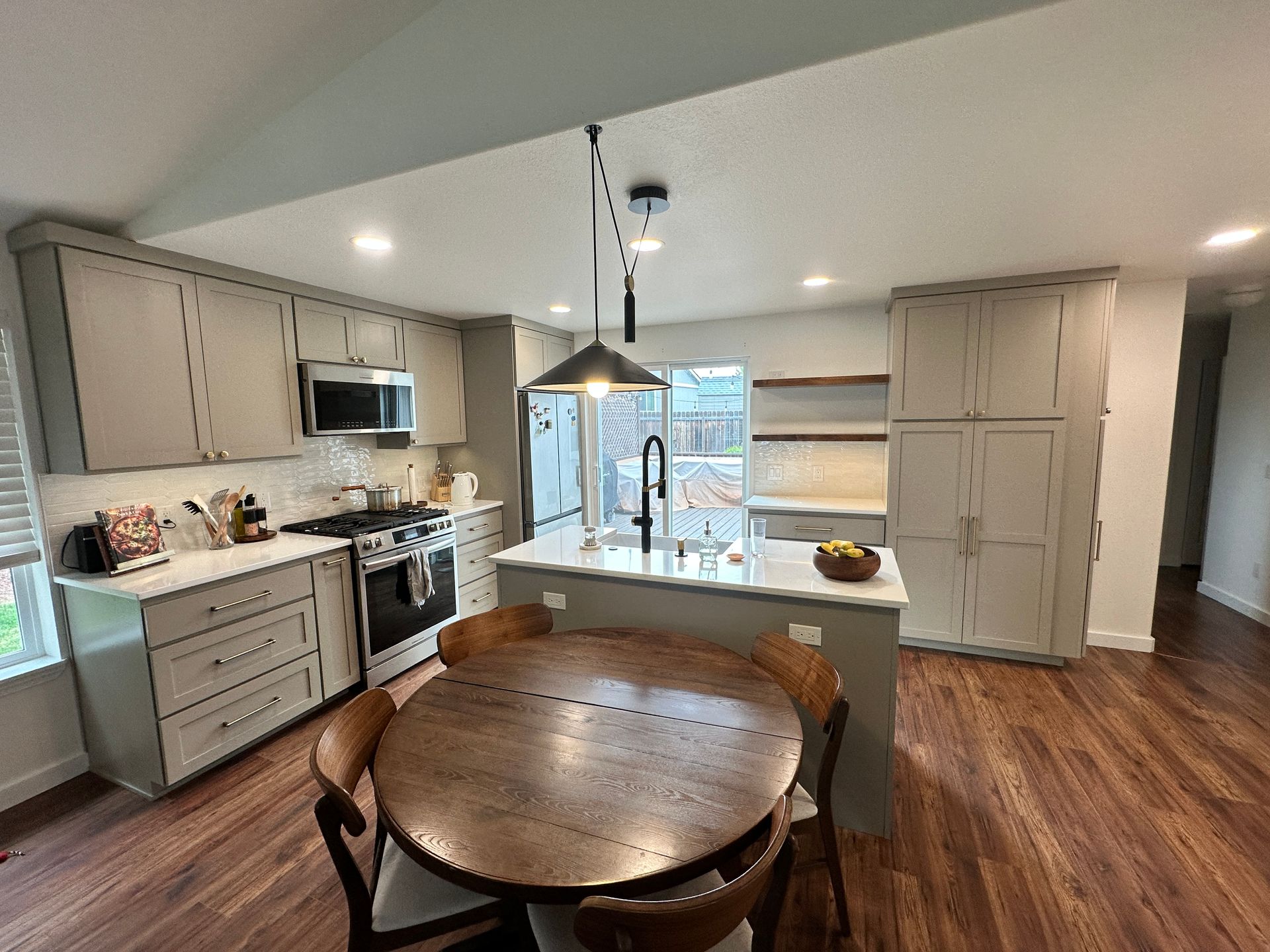 A kitchen with a table and chairs in it.