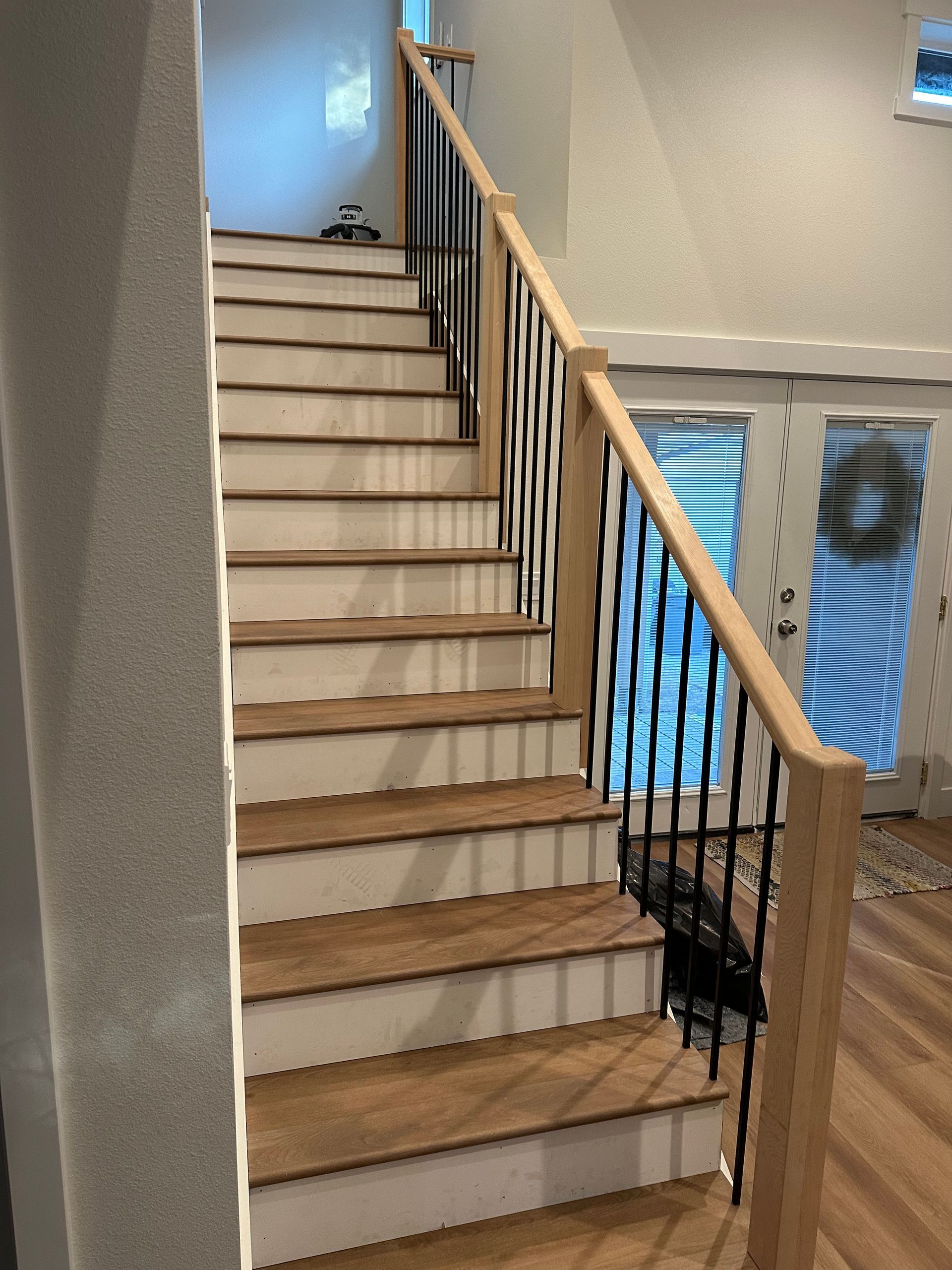 A staircase with wooden steps and a metal railing