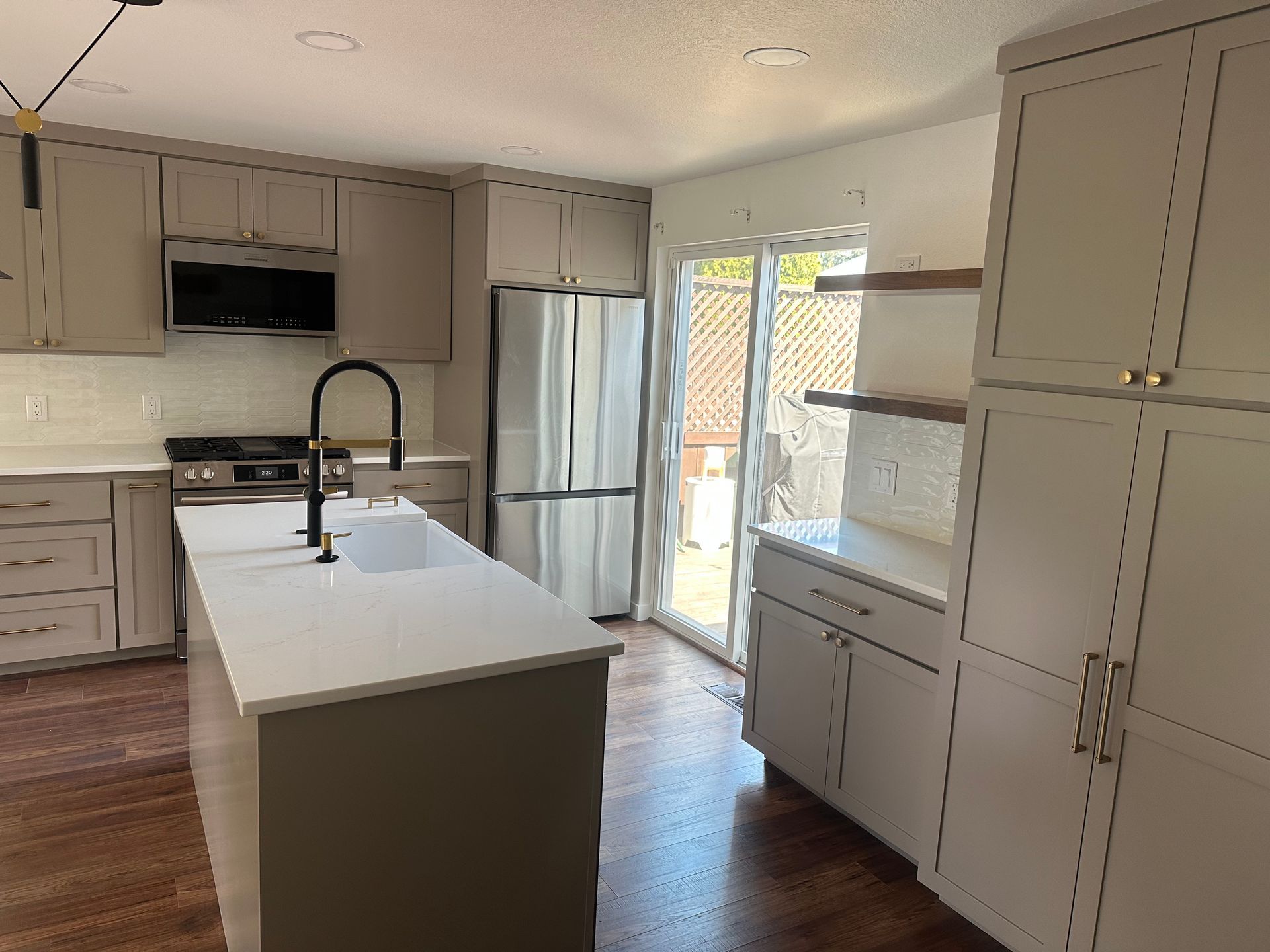 A kitchen with white cabinets and stainless steel appliances