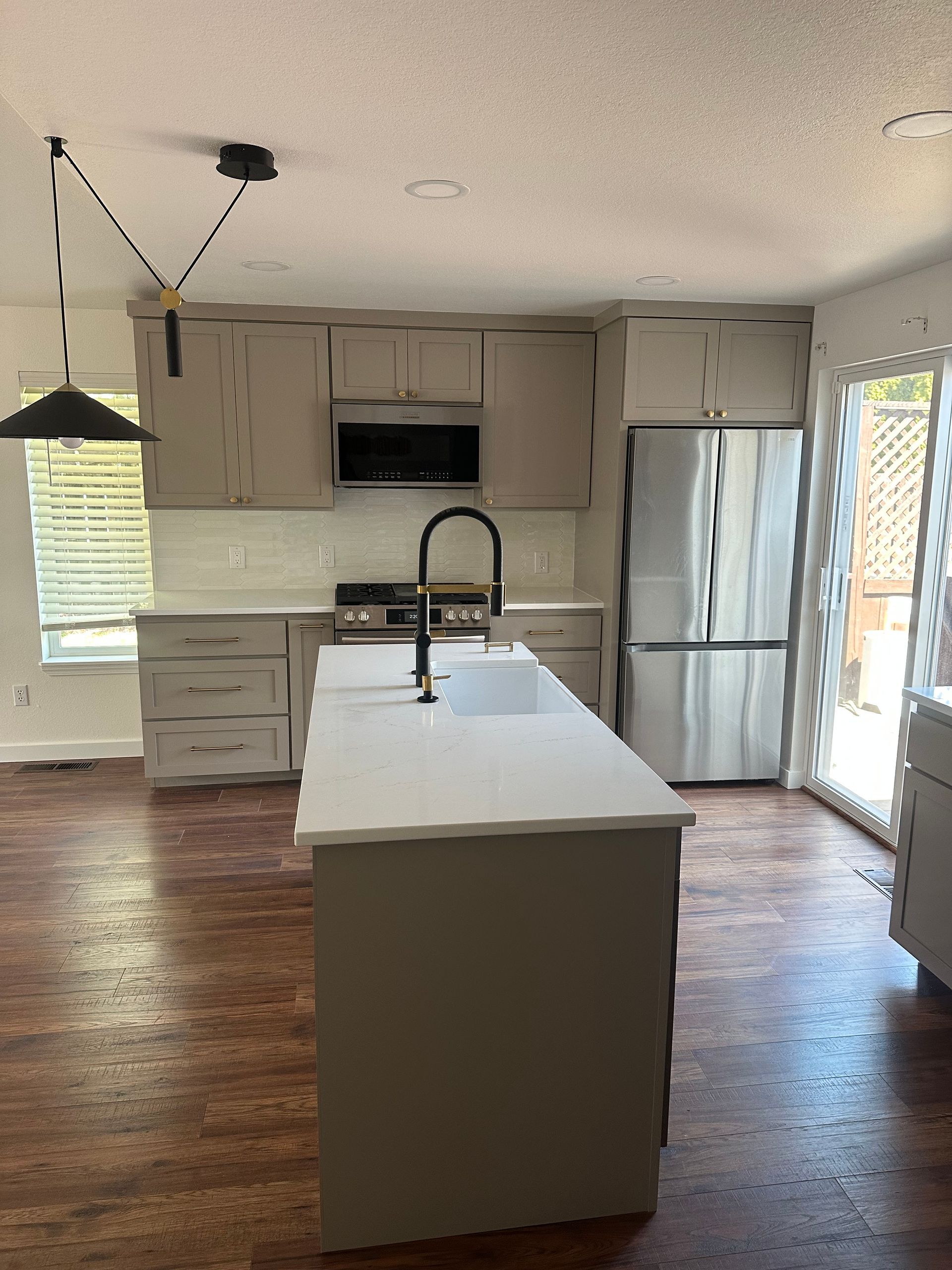 A kitchen with stainless steel appliances and a large island