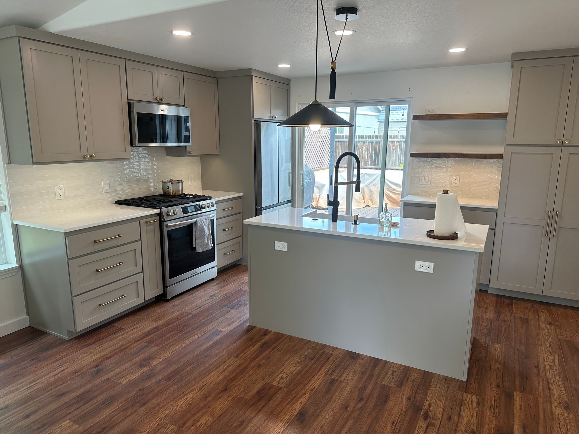 A kitchen with a large island and stainless steel appliances.