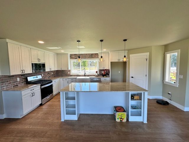 There is a large island in the middle of the kitchen.