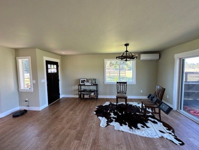 A living room with a cowhide rug and chairs