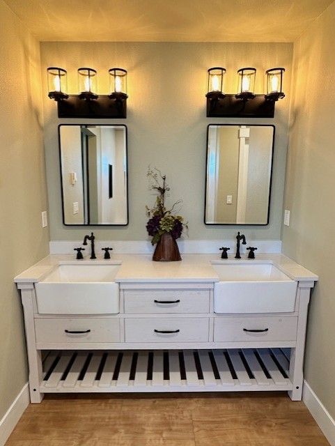 A bathroom with two sinks and two mirrors