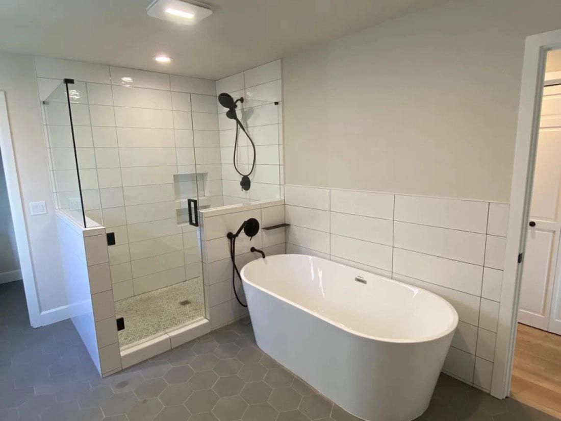 A bathroom with a bathtub and a walk in shower.