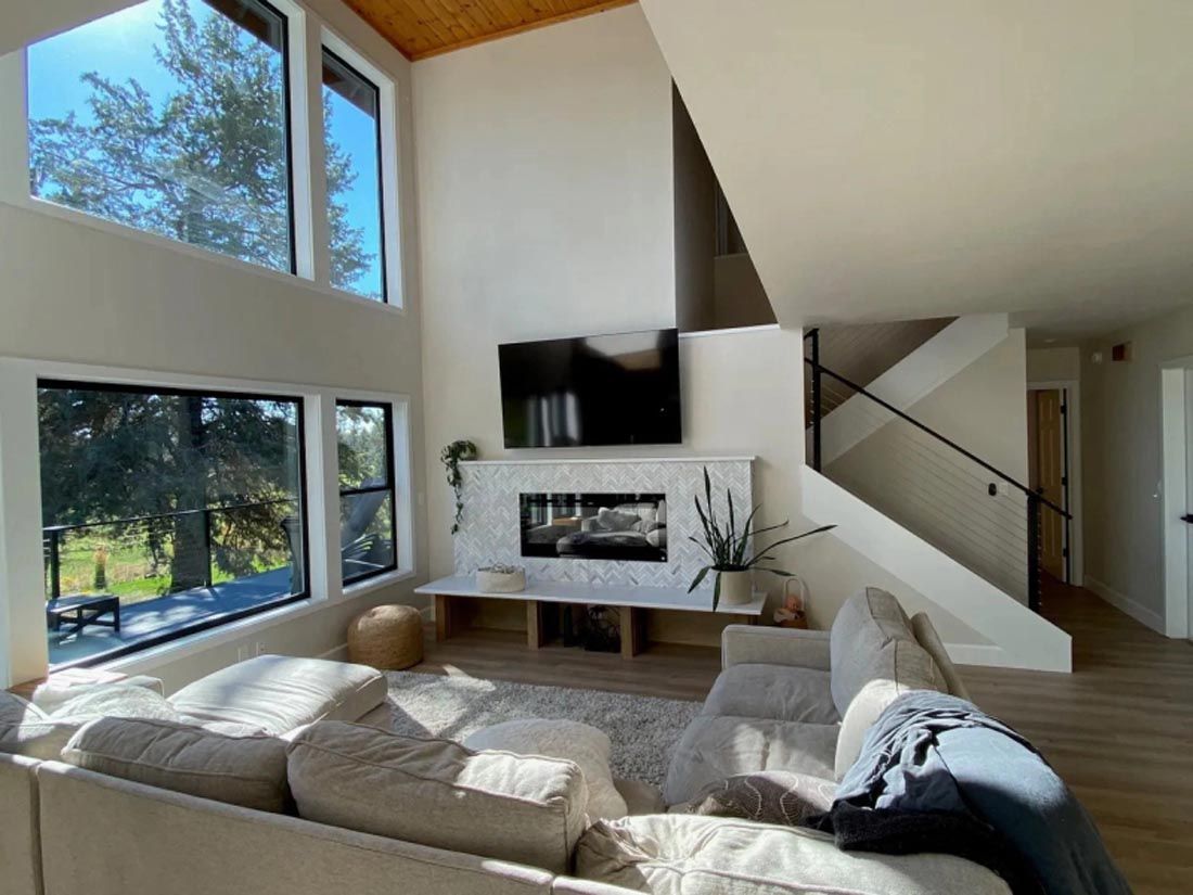 A living room with a couch , fireplace and television.