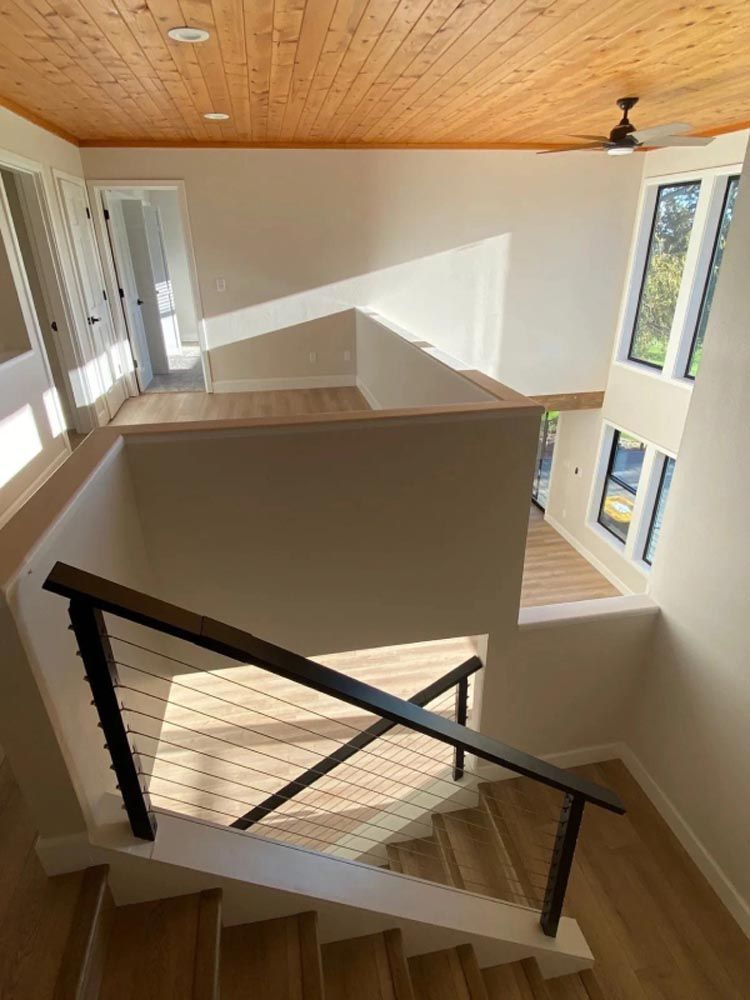 A view of a staircase from the second floor of a house.