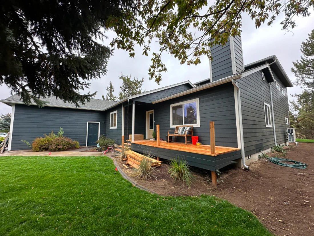 A large house with a large deck in front of it.