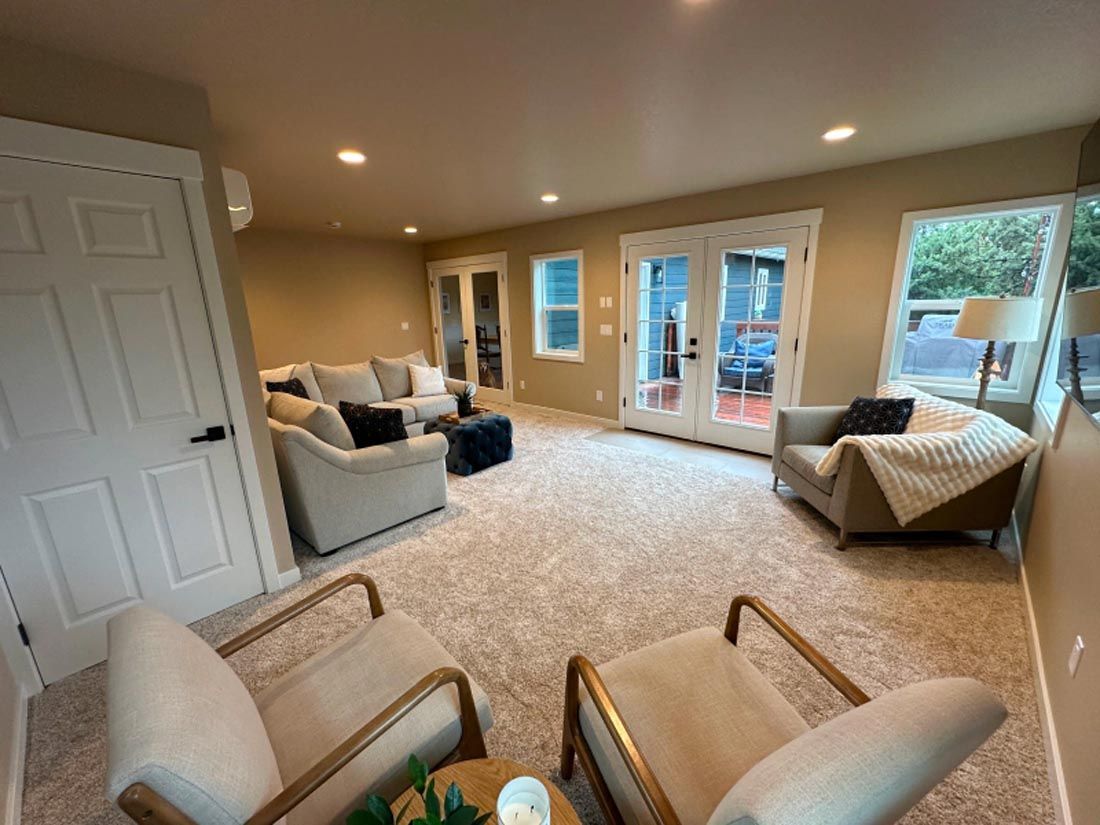 A living room with a couch , chairs , and a table.