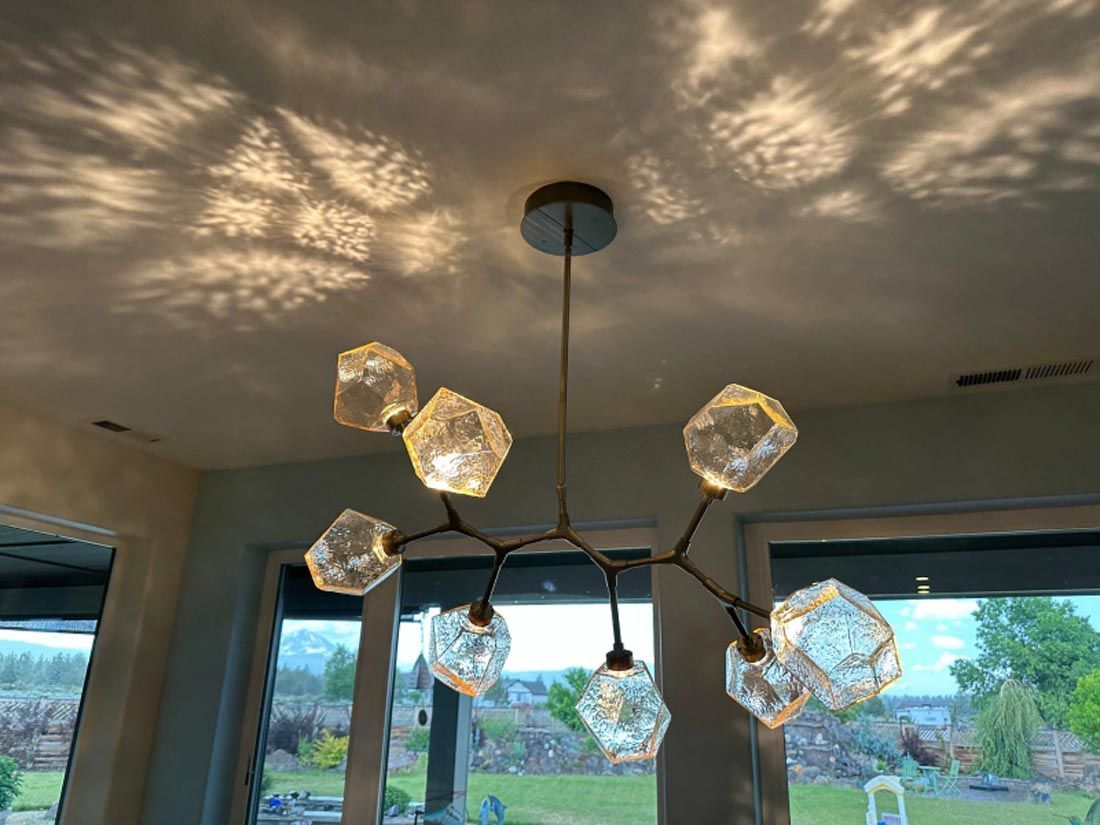 A chandelier is hanging from the ceiling in a room.