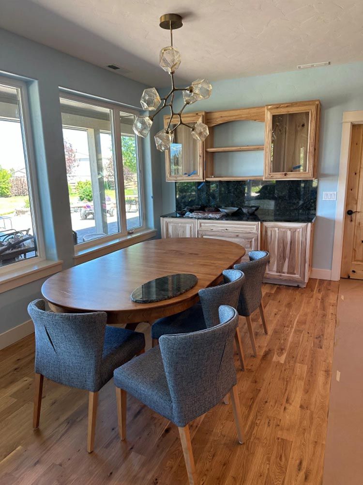 A dining room with a table and chairs and a chandelier.