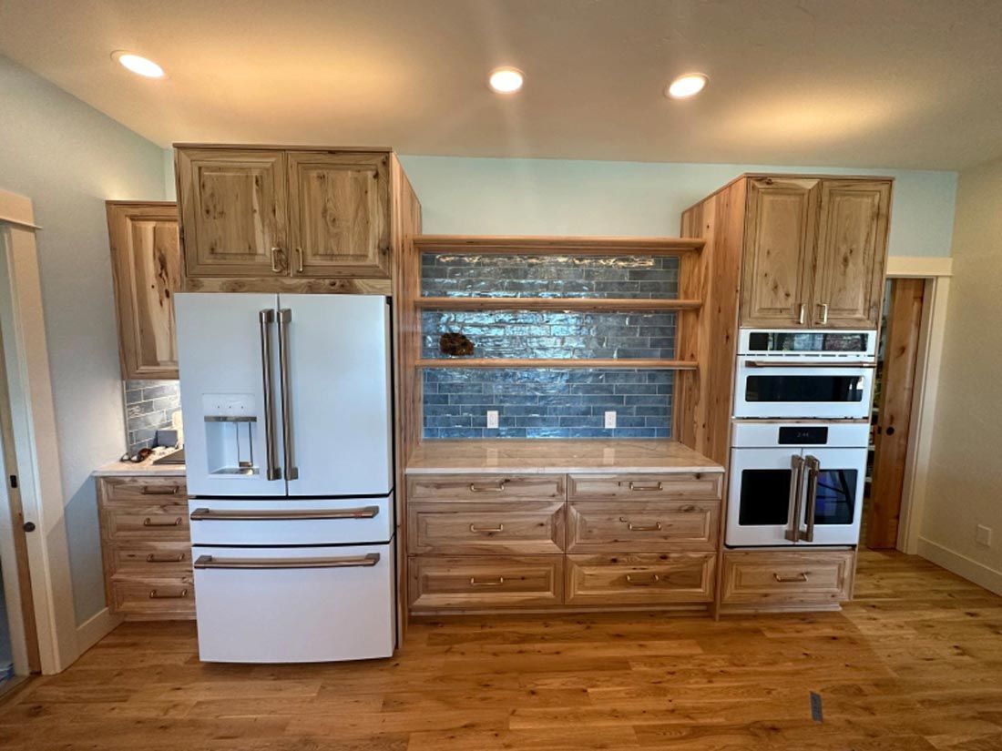 A kitchen with wooden cabinets and a white refrigerator.