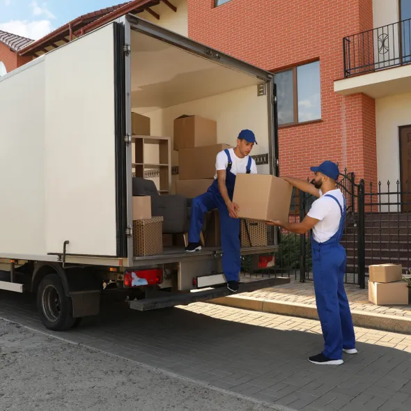 Hall's Hauling - Two men are loading boxes into a moving truck.