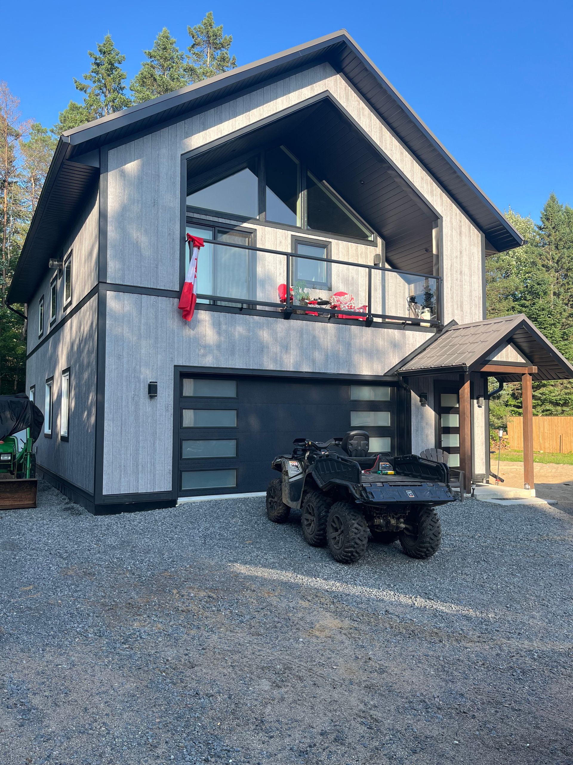 A four wheeler is parked in front of a house.