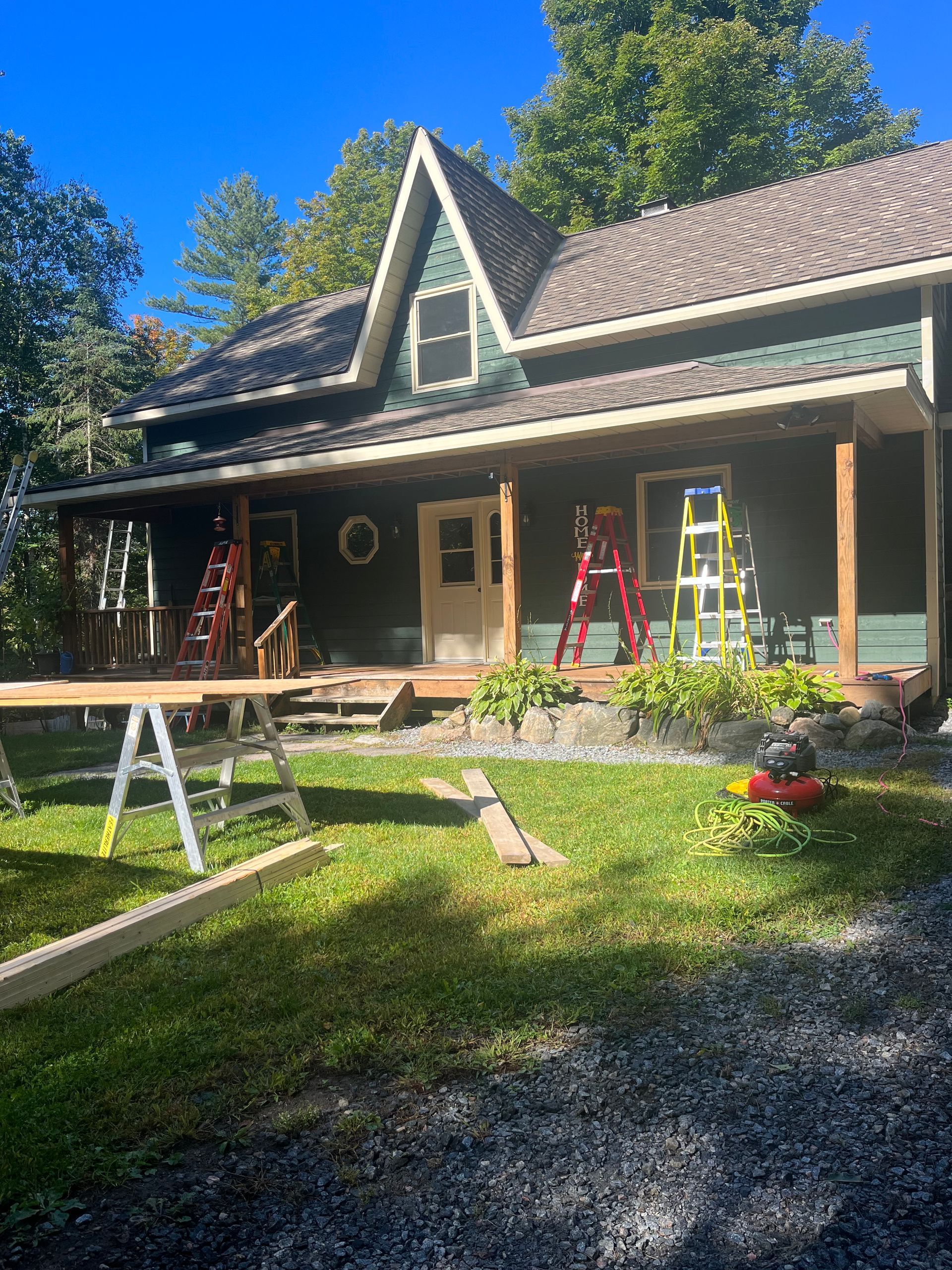 A house is being remodeled with a porch and a roof.