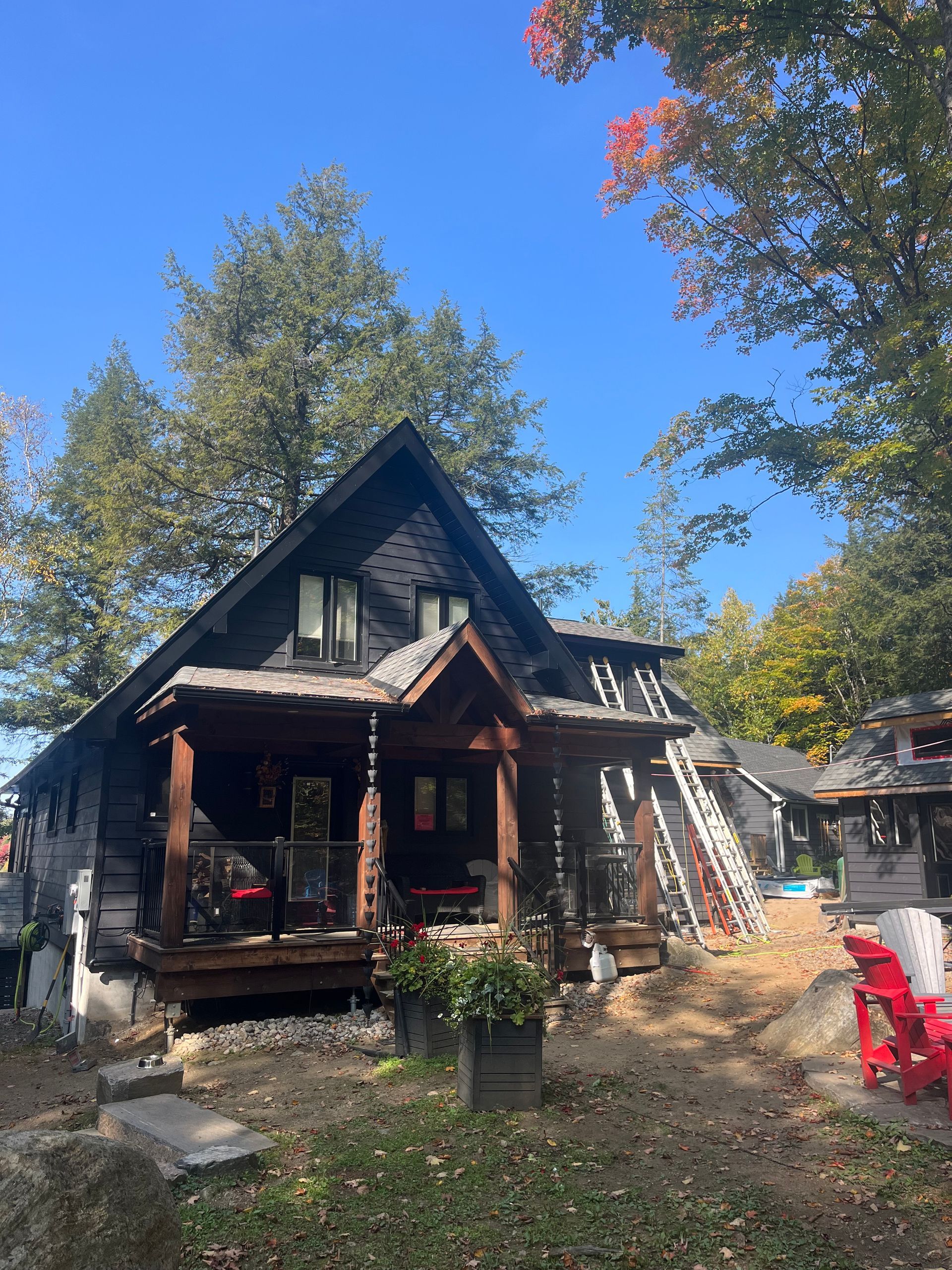 A small house with a porch and a blue sky in the background