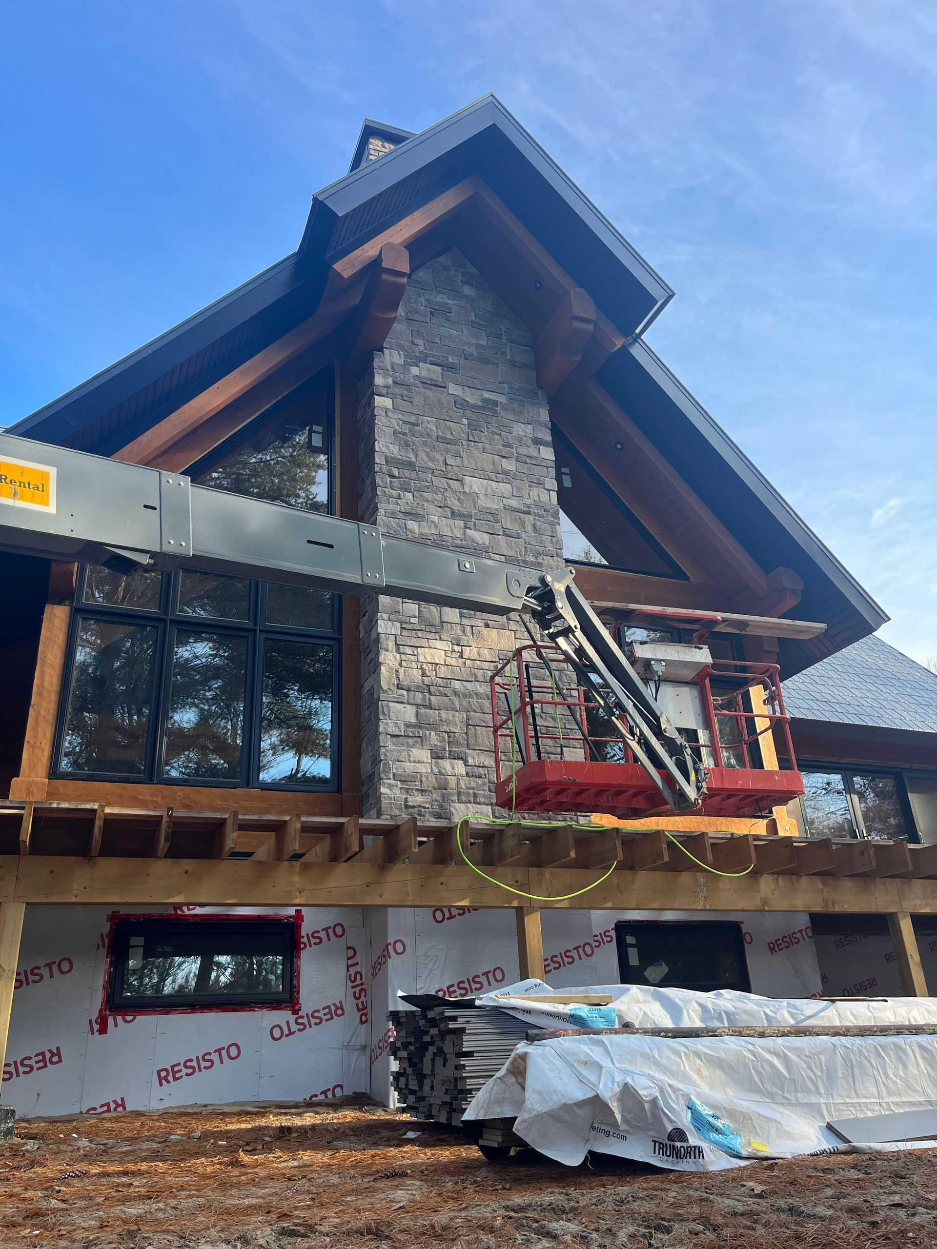 A large house with a lot of windows is being built.