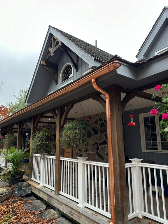 A house with a porch and a copper gutter