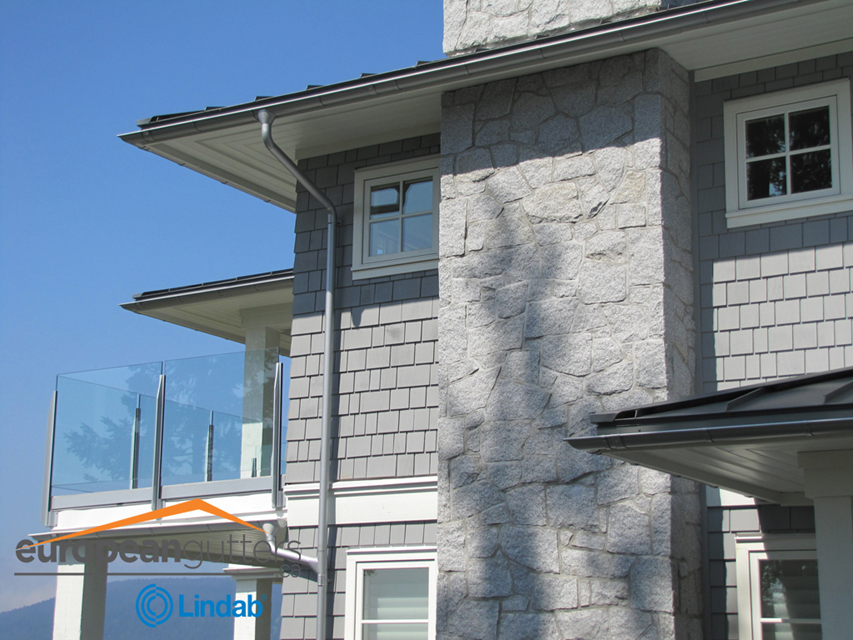 A large house with a gutter on the side of it
