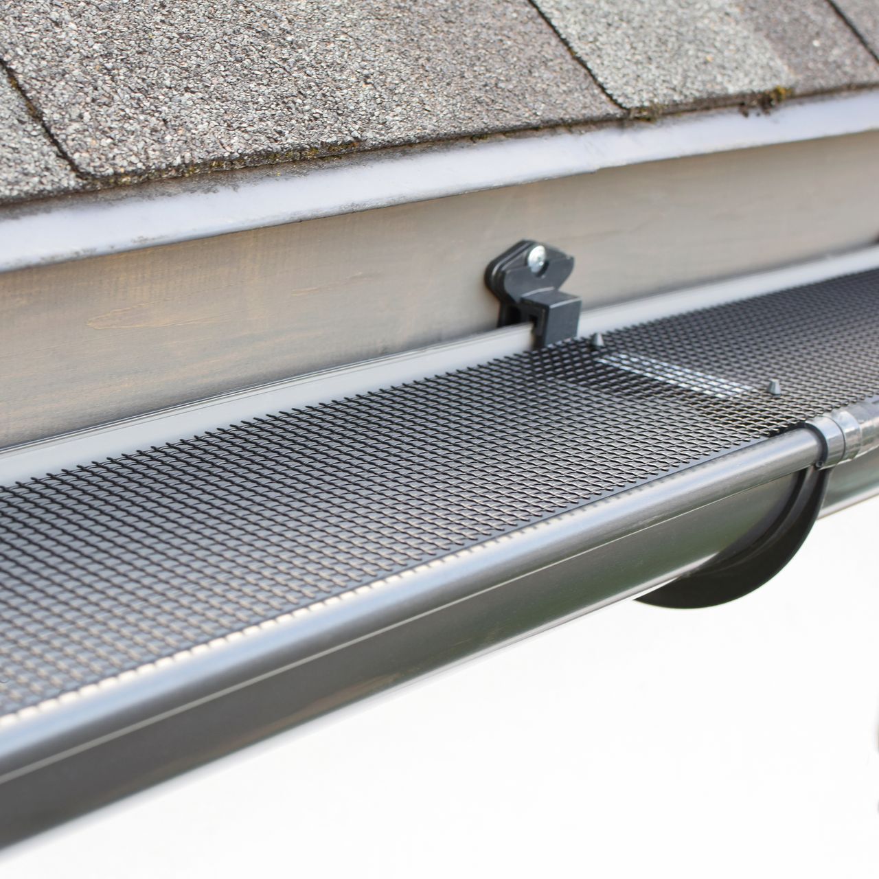 A gutter with a mesh screen attached to it