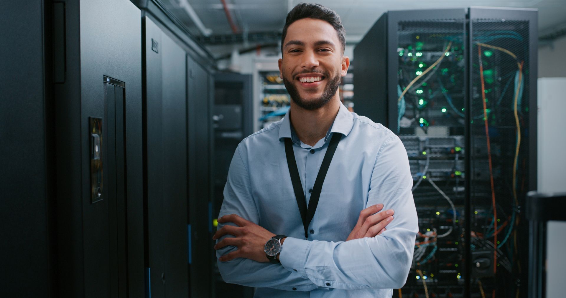 Shot of a young male IT service provider working in a server room. Shot of a young male IT service provider working in a server room.