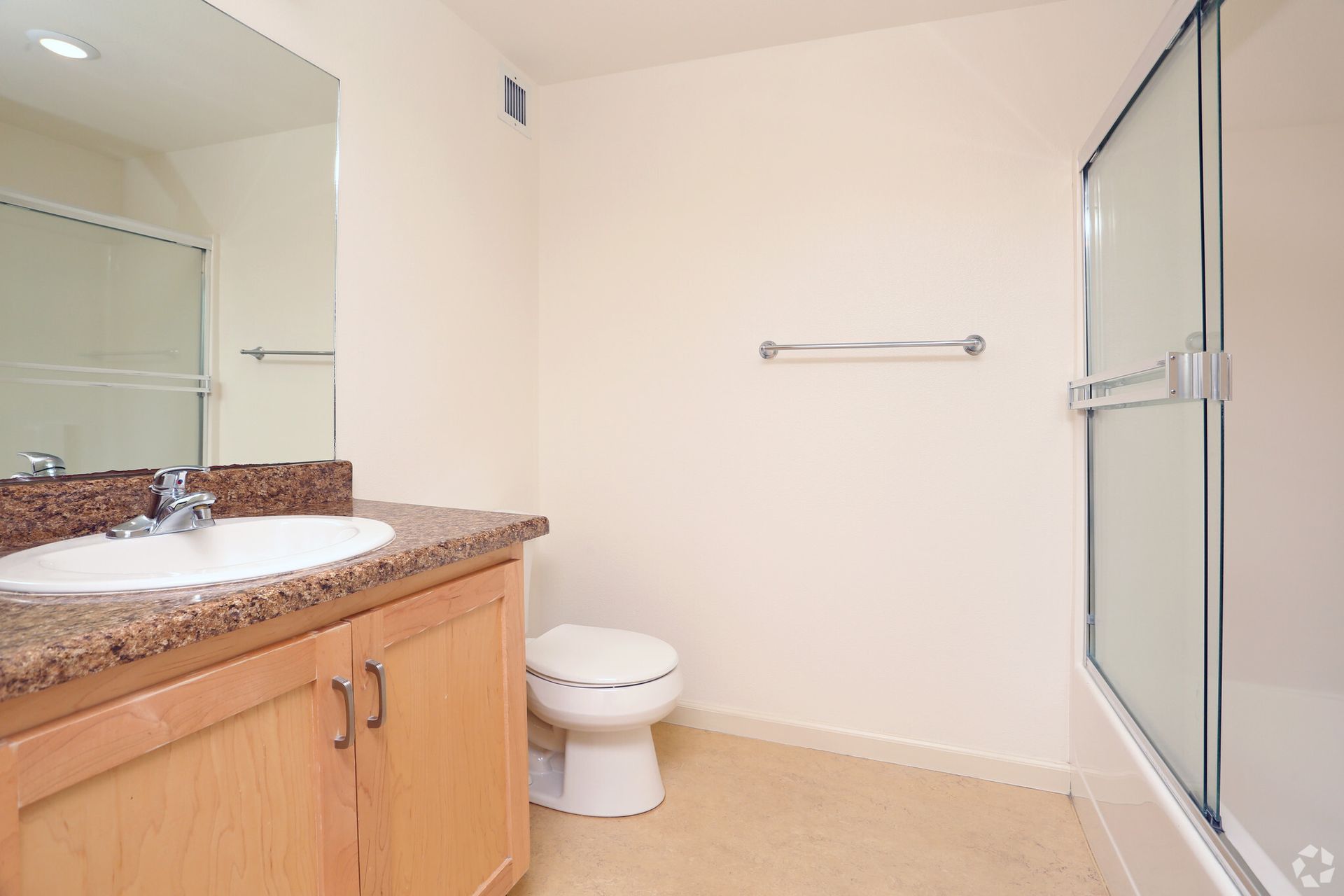 A bathroom with a sink , toilet , and shower.