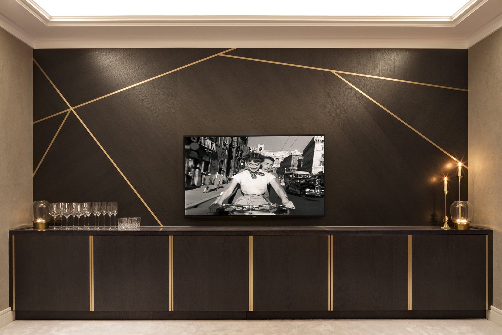 A black and gold wall with a tv on it