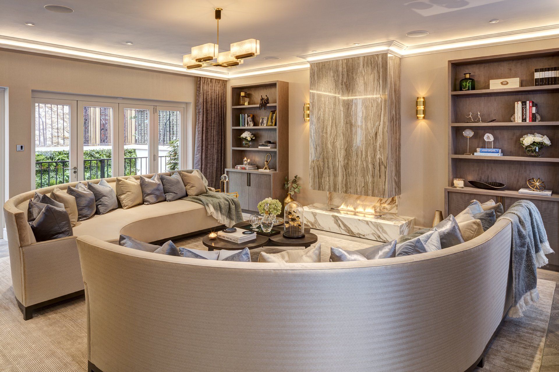 A living room with a curved couch and a fireplace